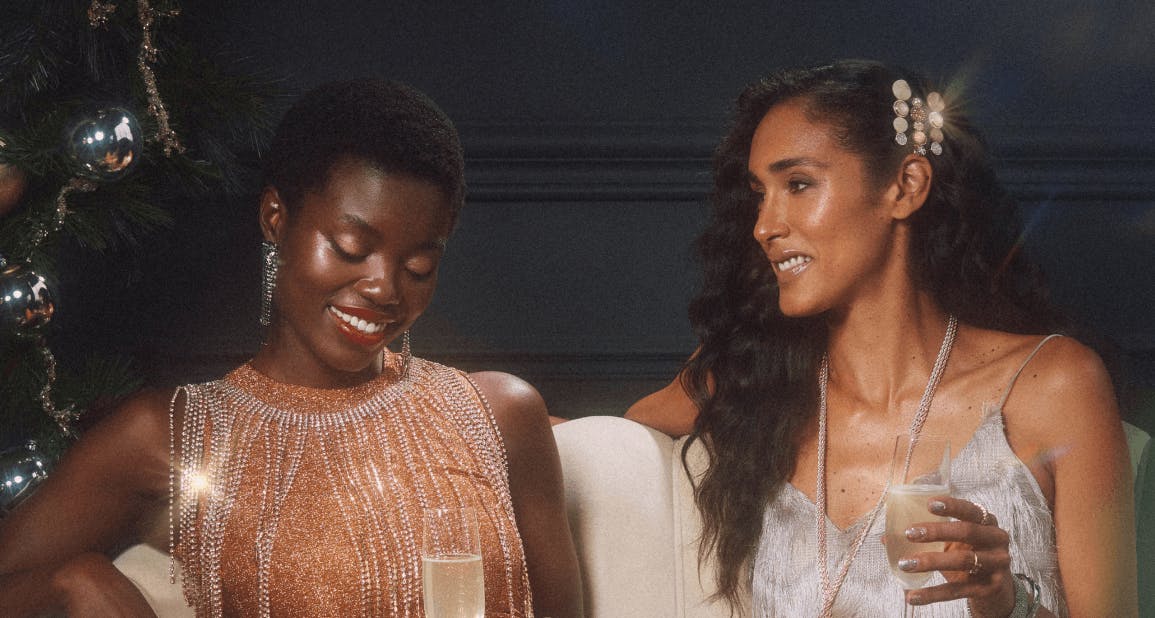 Two woman smiling and drinking champagne