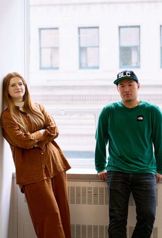 Two Antisocial team members posing by a window