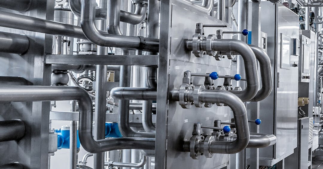 Industrial stainless steel pipe fittings with control valves and connectors, integrated in a processing system for durable and efficient mechanical operations.