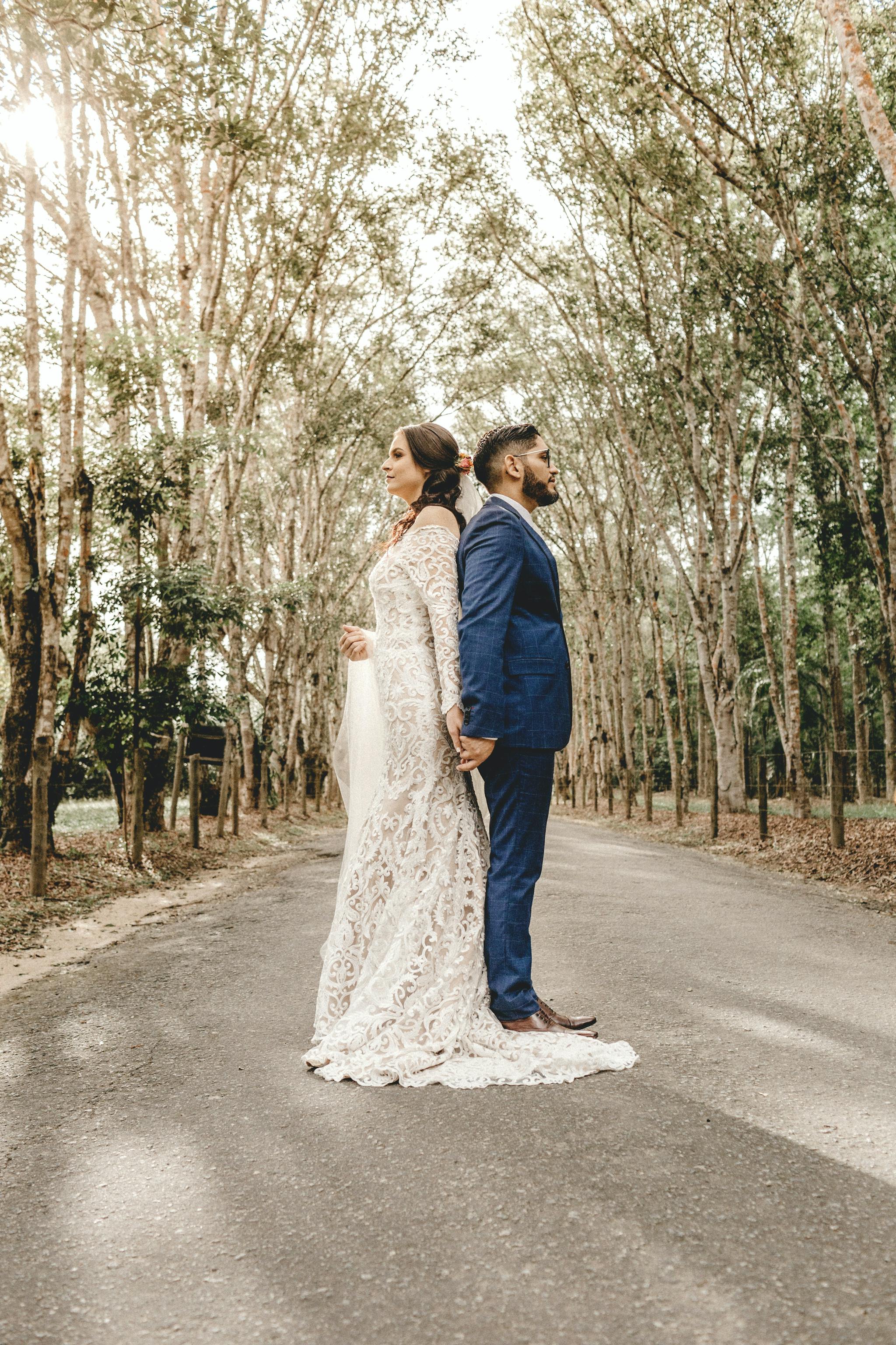 Bride and Groom in front of trees on a street