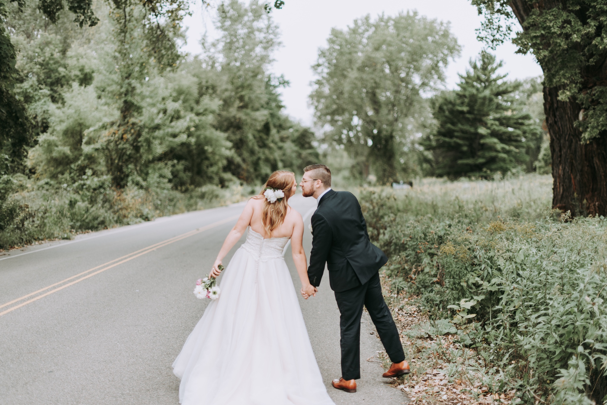 Couple kissing on street after wedding