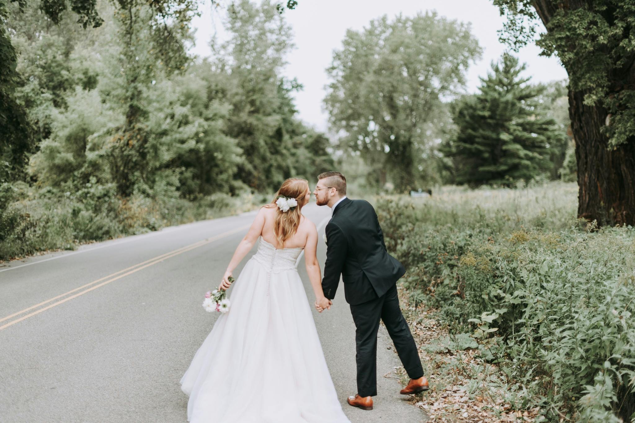 Couple kissing on street after wedding