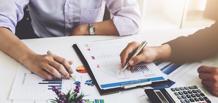 Stock photo of two people viewing charts