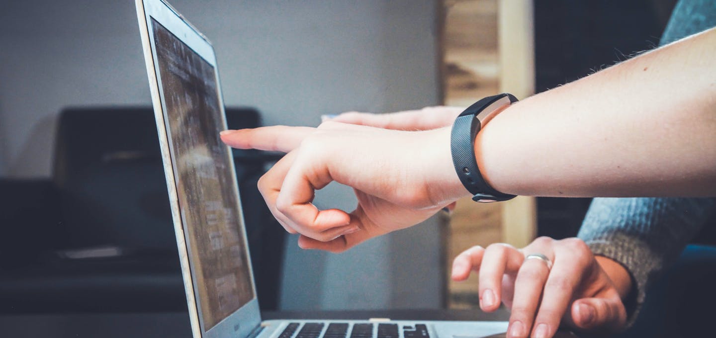 hands pointing to laptop