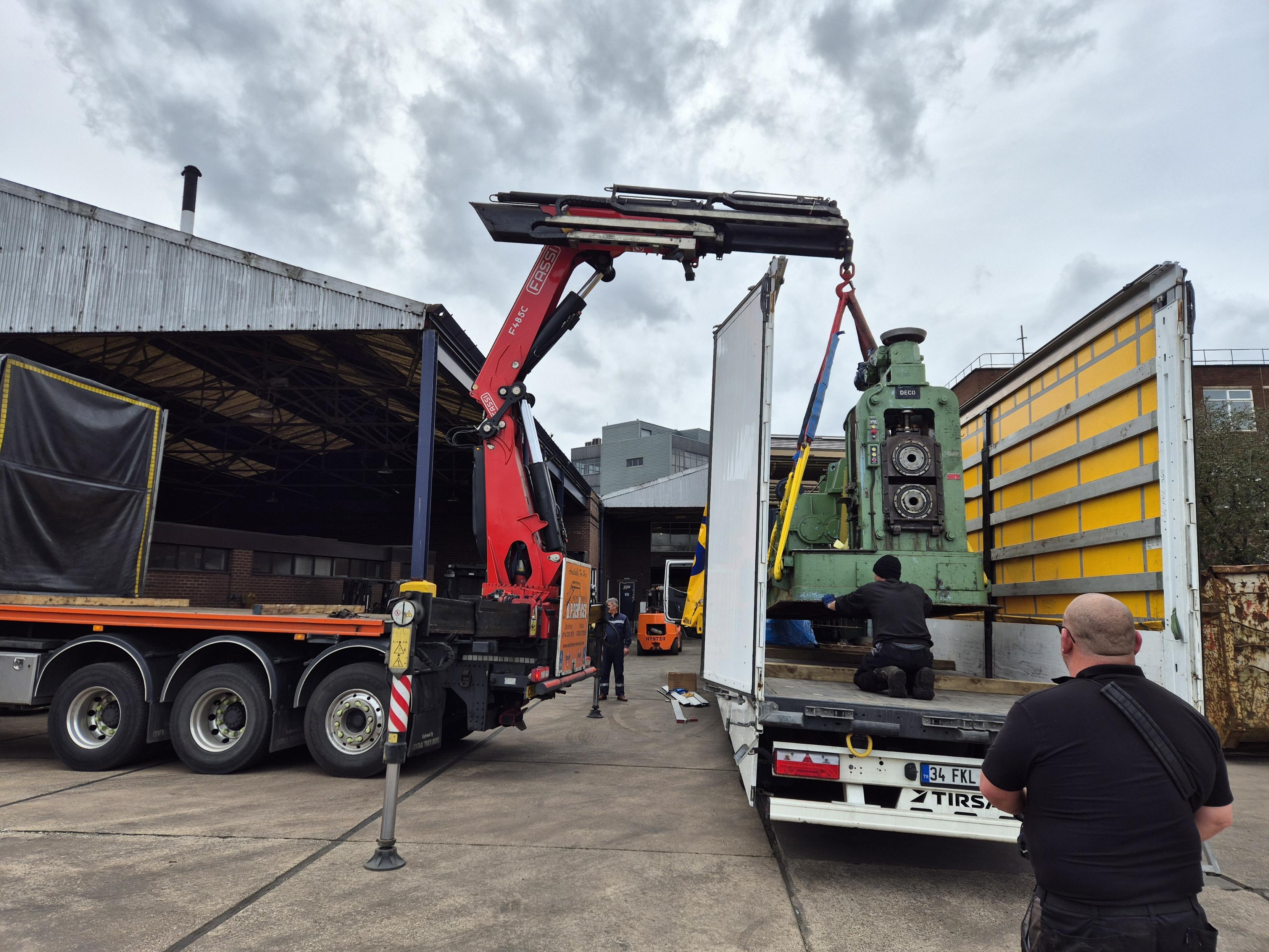 Image of a crane lifting an item onto a lorry
