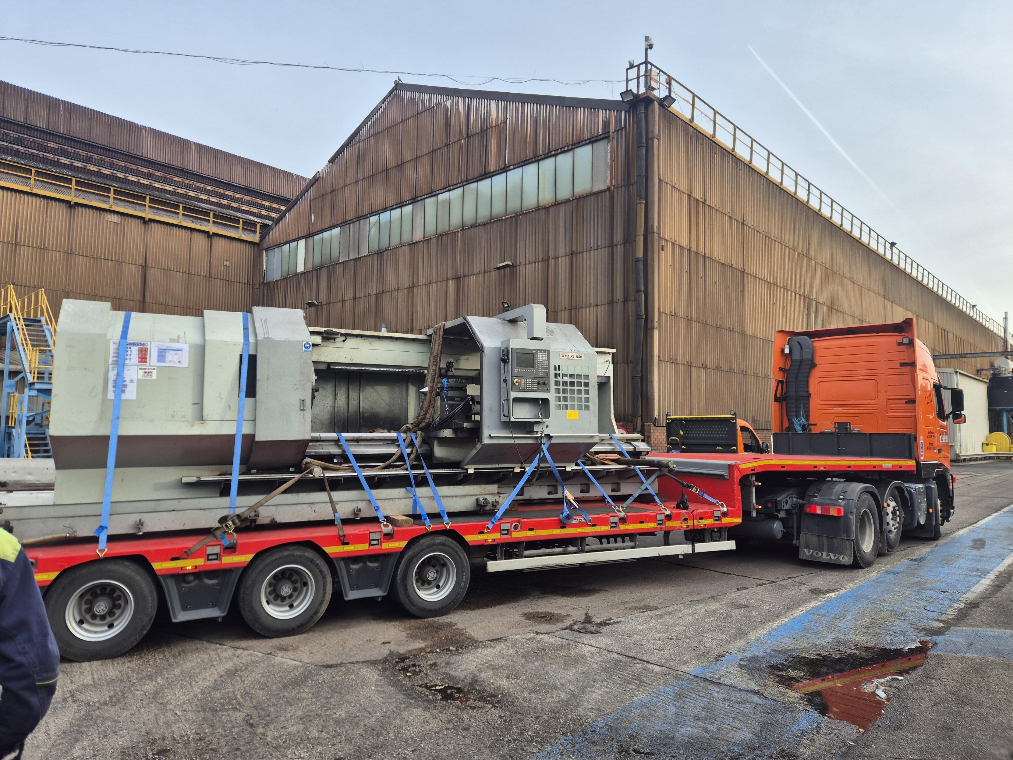 Image of a flat bed lorry transporting machinery