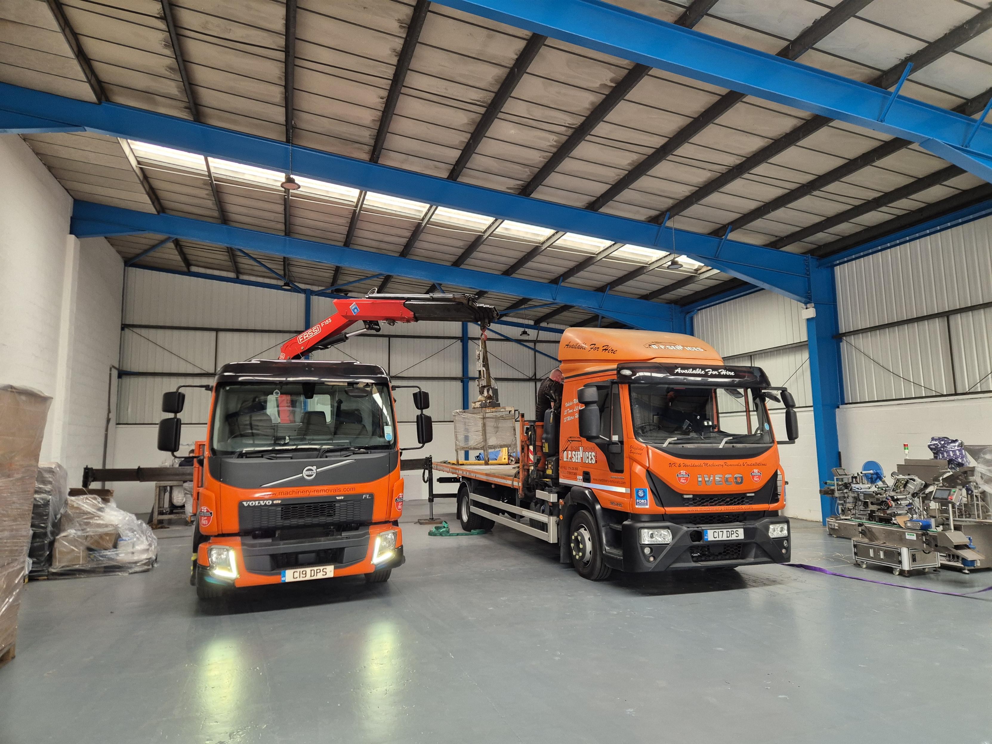 Image of two trucks in a warehouse