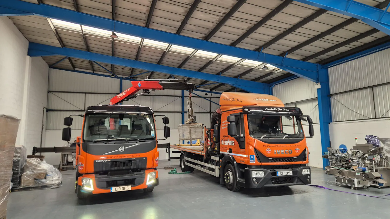 Image of two trucks in a warehouse