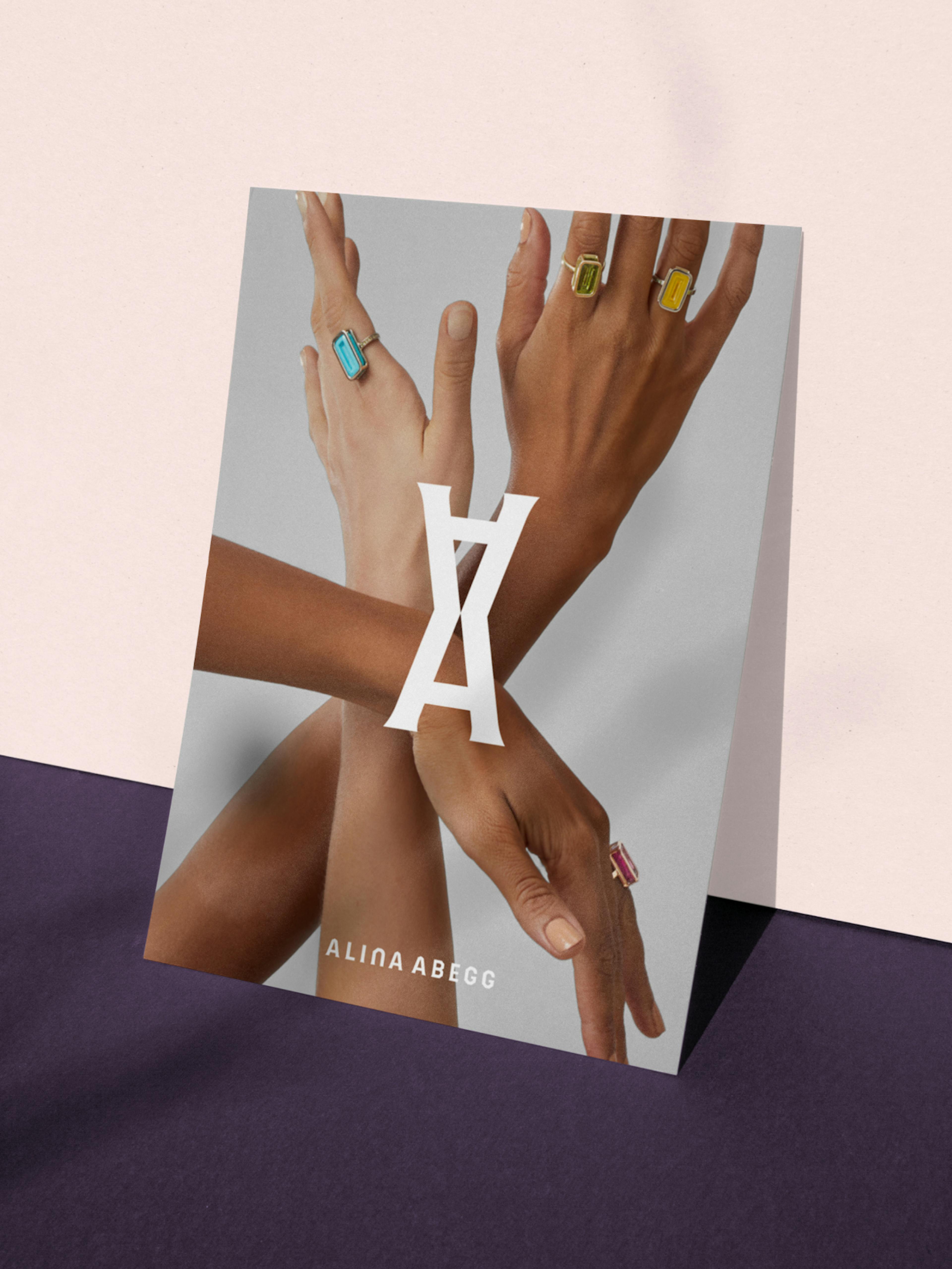 Alina Abegg – Branding, Packaging, Online Store "A cosmic shopping experience": Mockup showing hands adorned with rings and the Alina Abegg logo by HY.AM