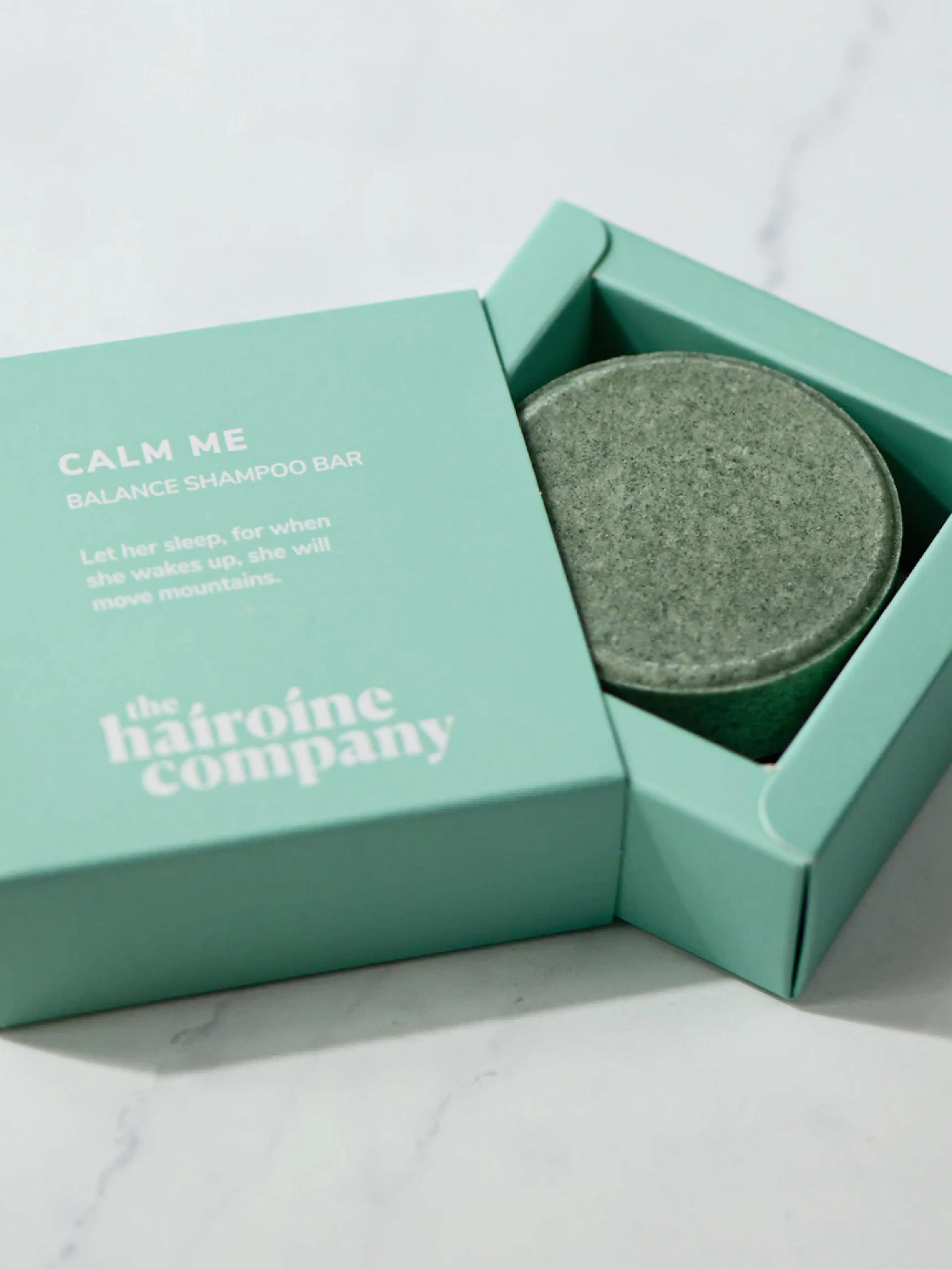 The Hairoine Company – Branding "A hair care brand for confident women": Mockup showing a green shampoo bar in its branded packaging by HY.AM