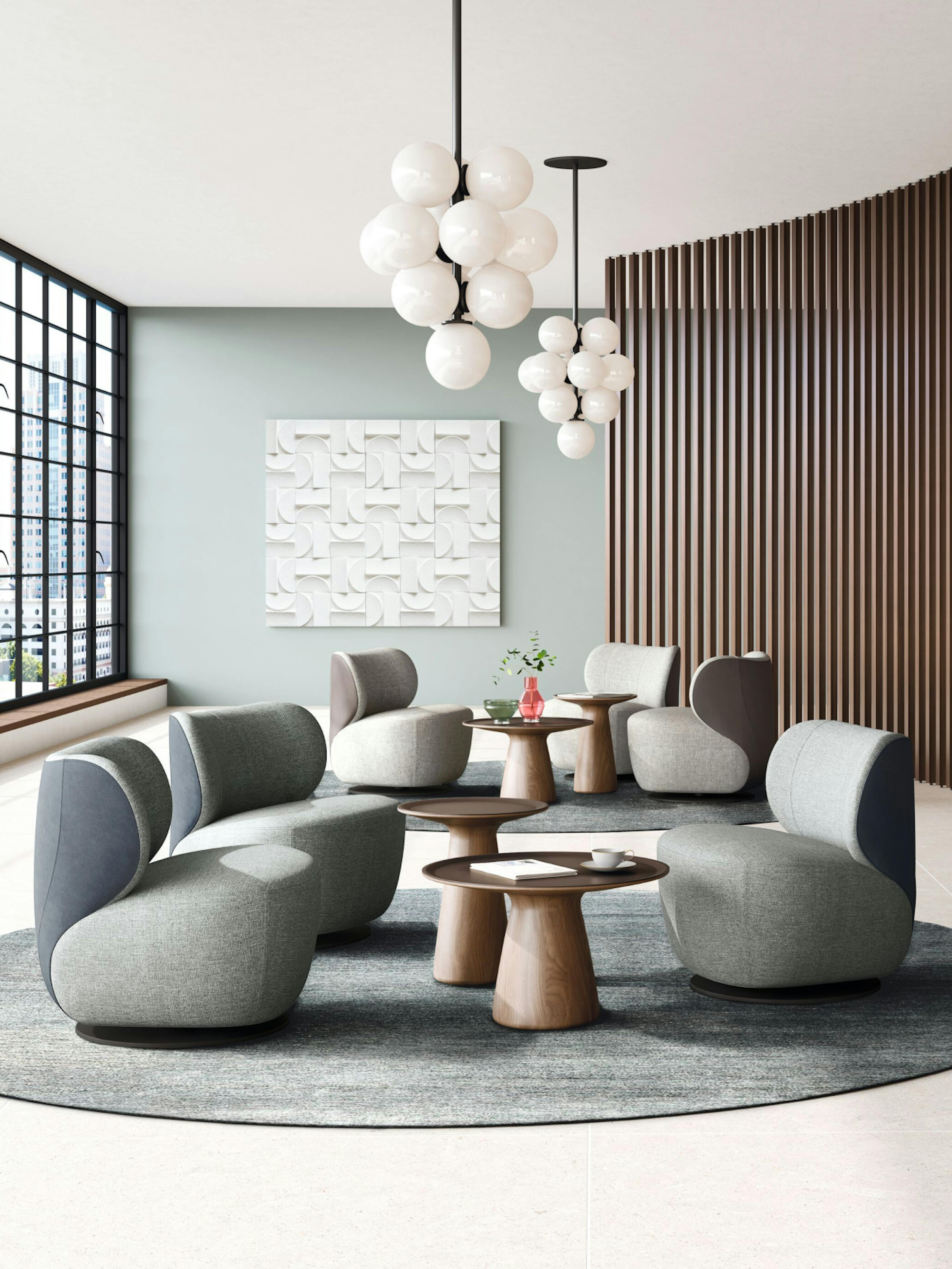 Walter Knoll – Product Promotion Campaign "Timeless comfort for your home": Photo showing a modern living room arrangement with grey upholstered chairs and wooden side tables by HY.AM