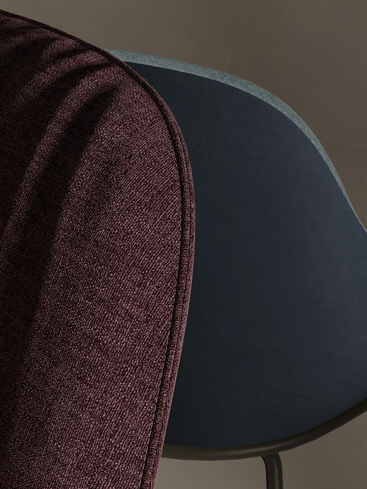 Walter Knoll – Brand Design, E-Commerce, Experience Design "The essence of excellence": Photo showing a close-up of a textured burgundy fabric curving around a dark blue upholstered chair x HY.AM Studios