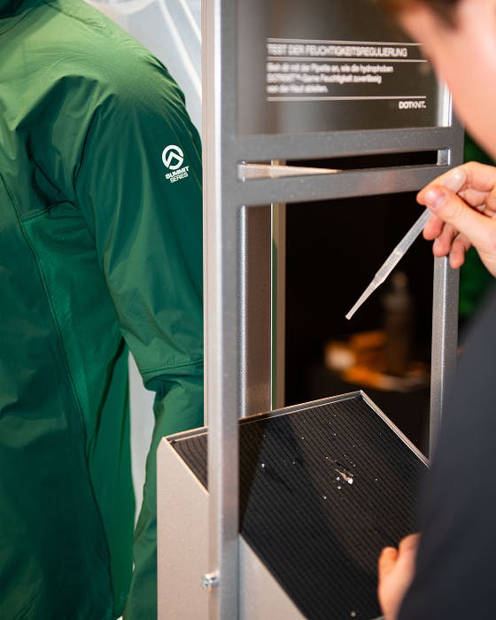 The North Face – Brand Activation "Summit Series Brand Activation": Photo showing a green jacket with the Summit Series logo and a person testing fabric breathability x HY.AM Studios