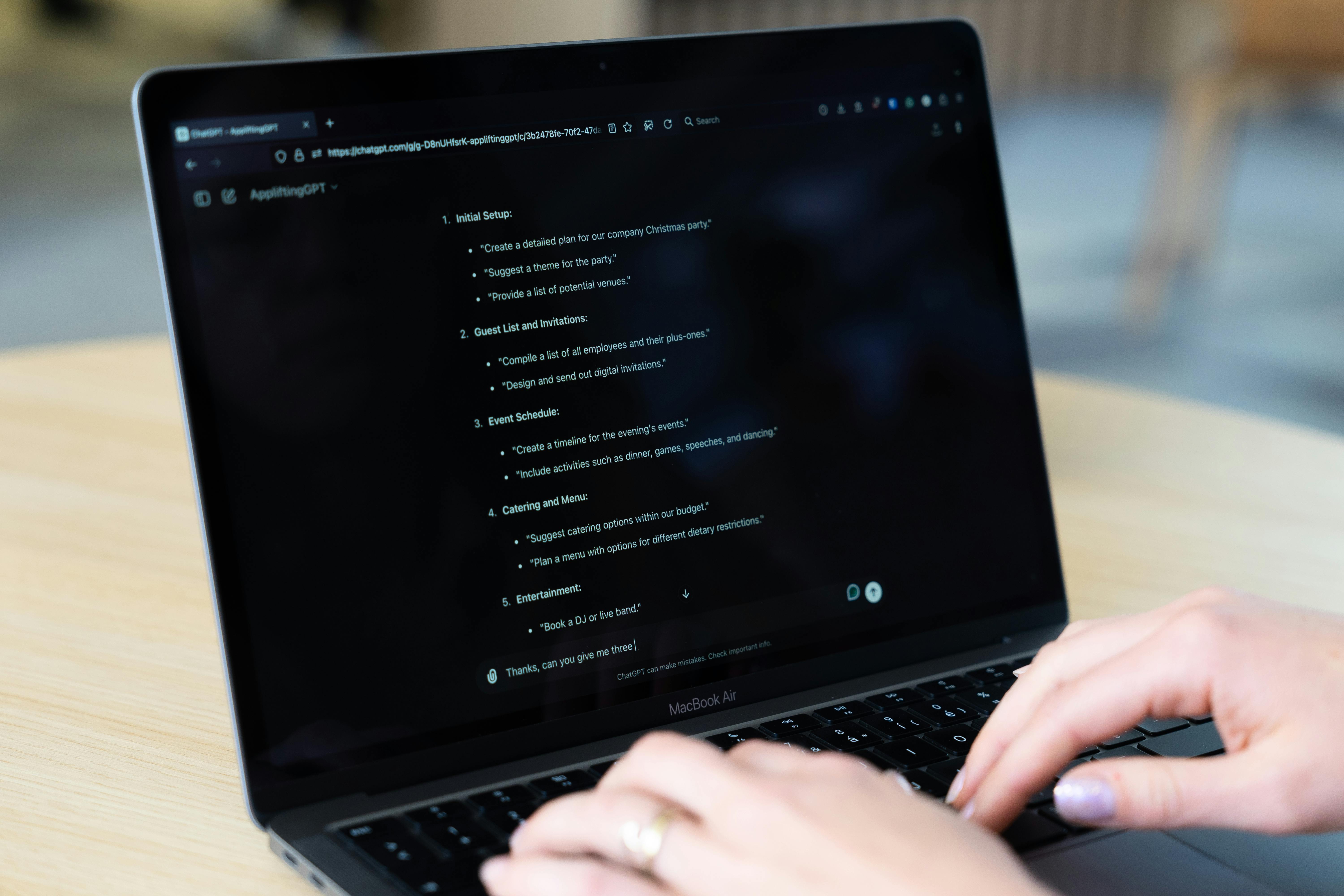 Close up of a laptop screen with a prompt response listing various tasks and ideas for a christmas party