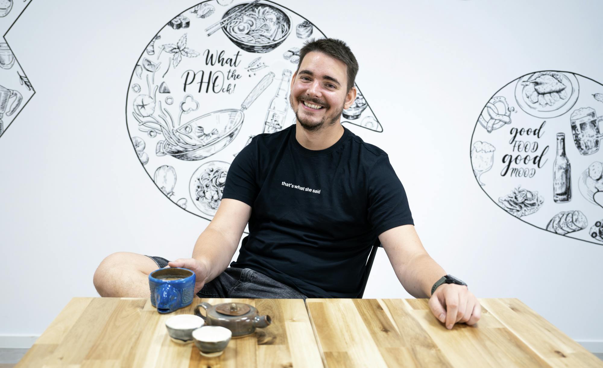 quality assurance tech lead sitting by a desk and smiling at the camera