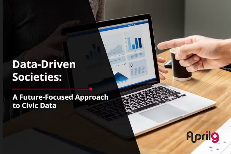 Laptop on a desk displaying data charts and graphs. A hand points at the screen. Text overlay reads 'Data-Driven Societies: A Future-Focused Approach to Civic Data' with the April9 logo in the corner.