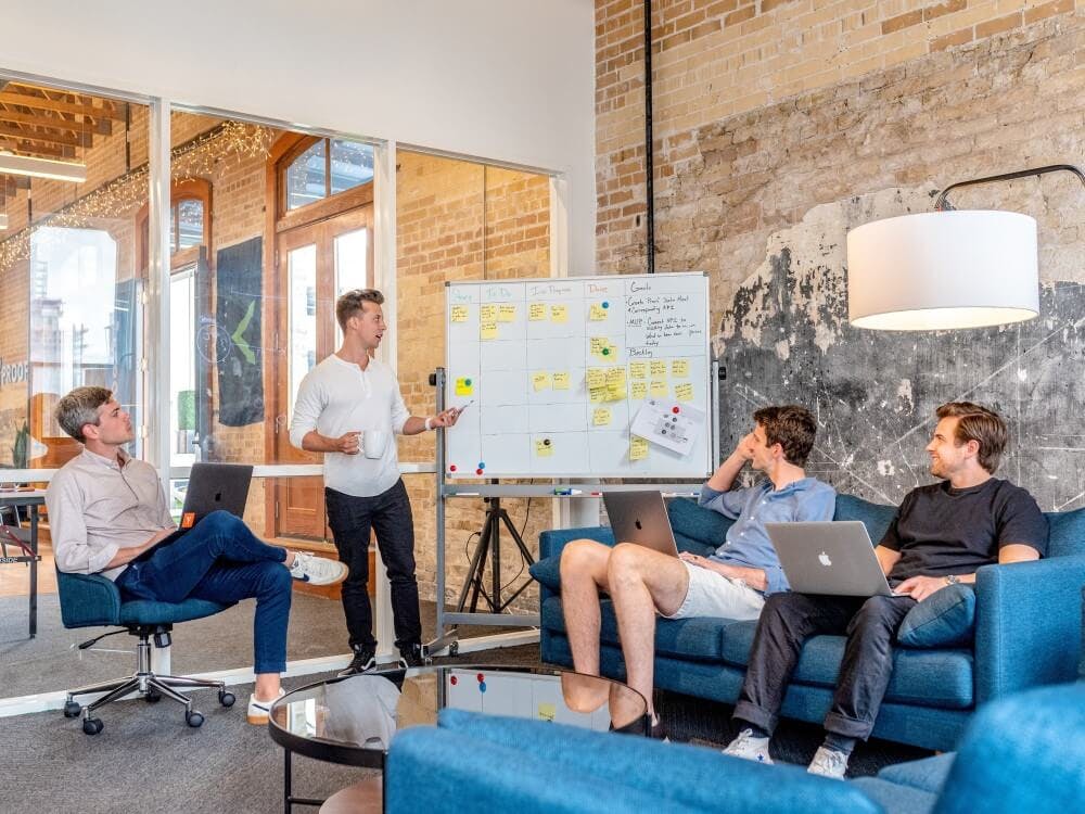 Image showing 4 people next to a white board.