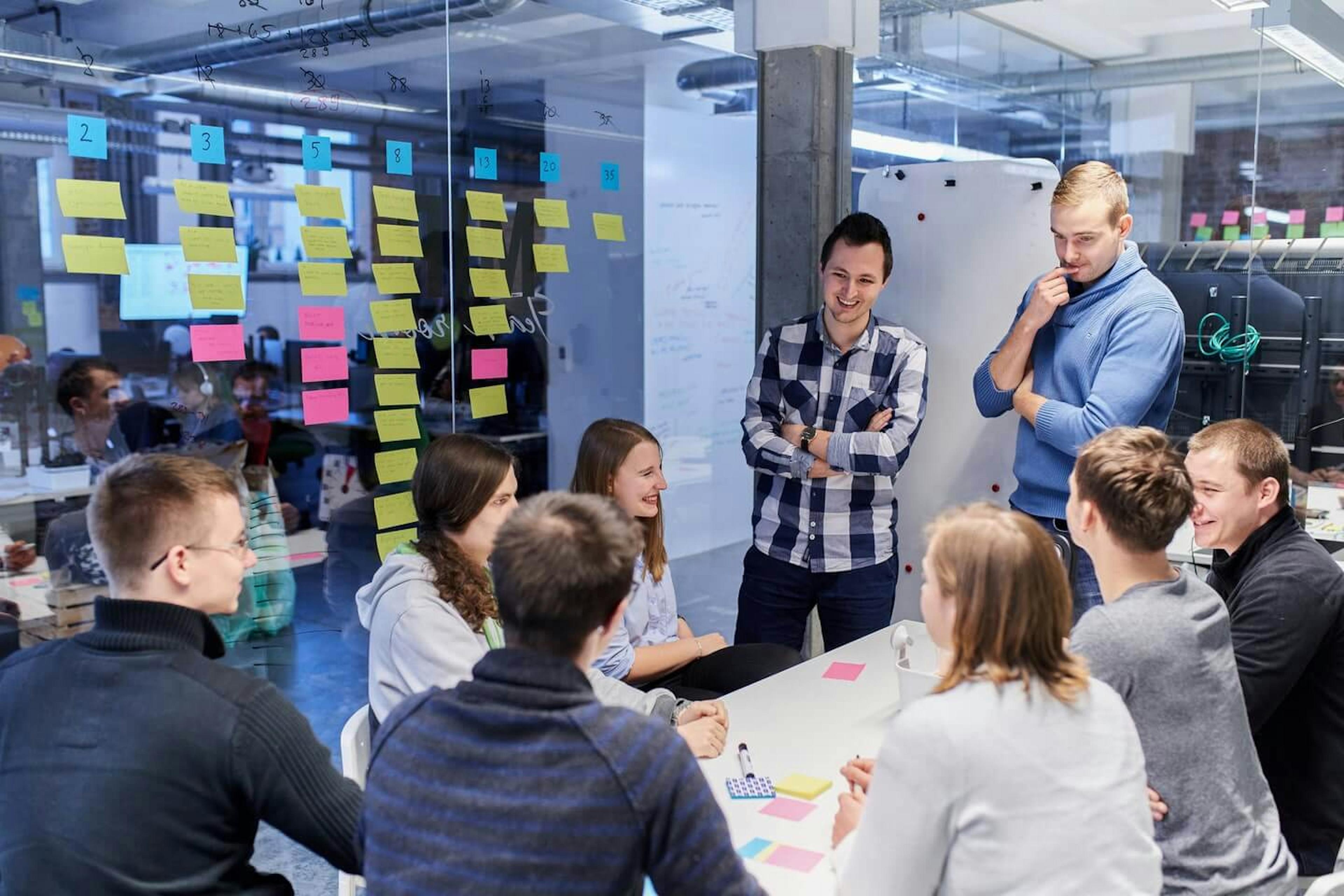 Image showing people in a meeting room during one of the Scrum's ceremonies.