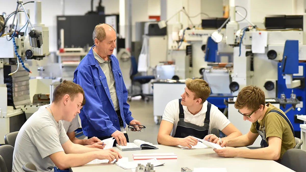 Group of young people in technical vocational training with teacher