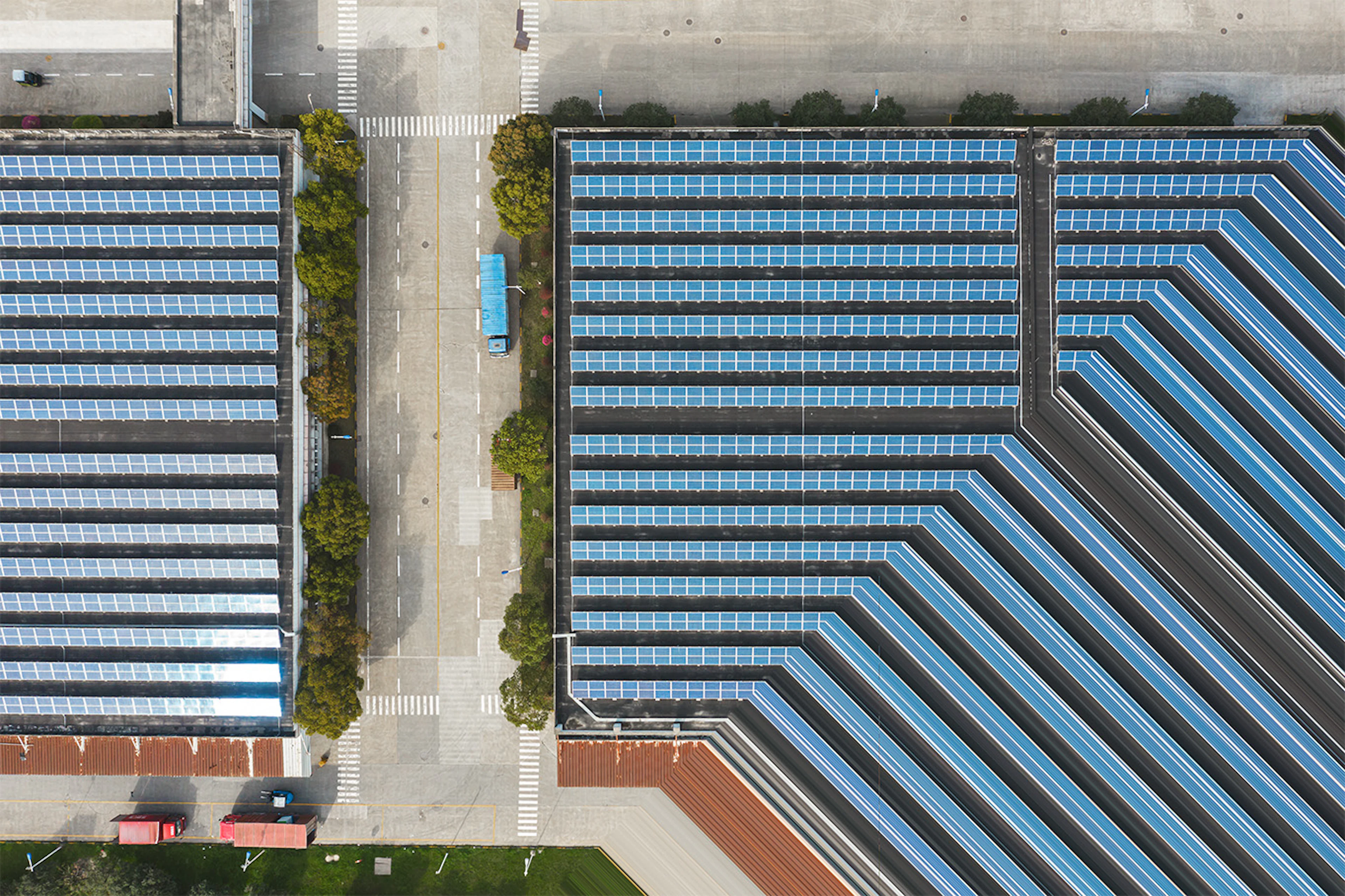 Aerial view of large rows of solar panels covering a commercial site