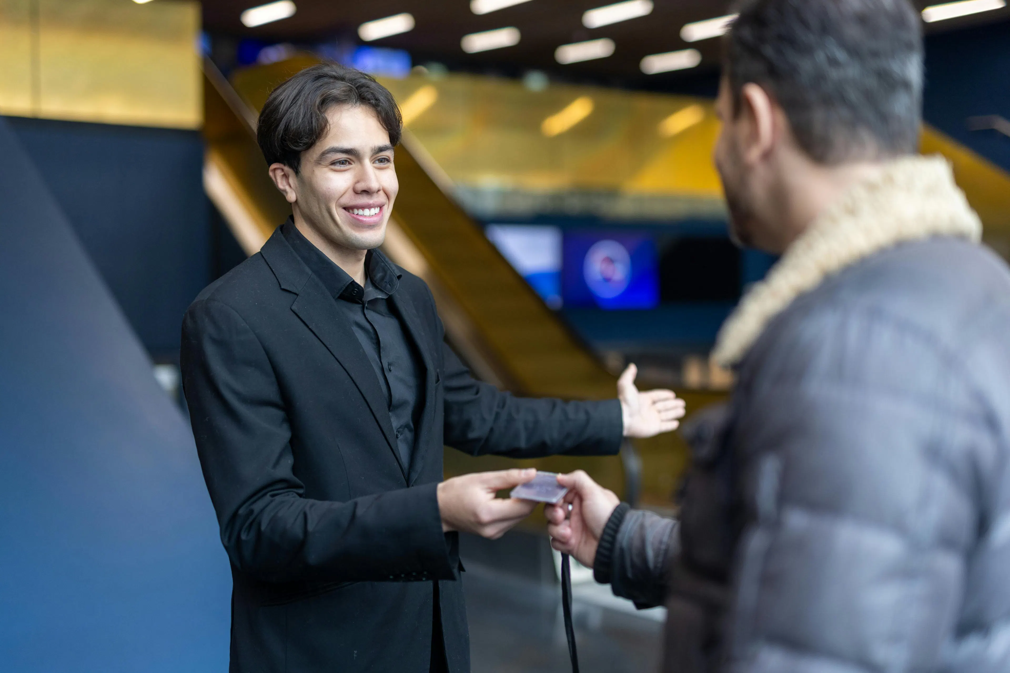 A receptionist welcoming a visitor