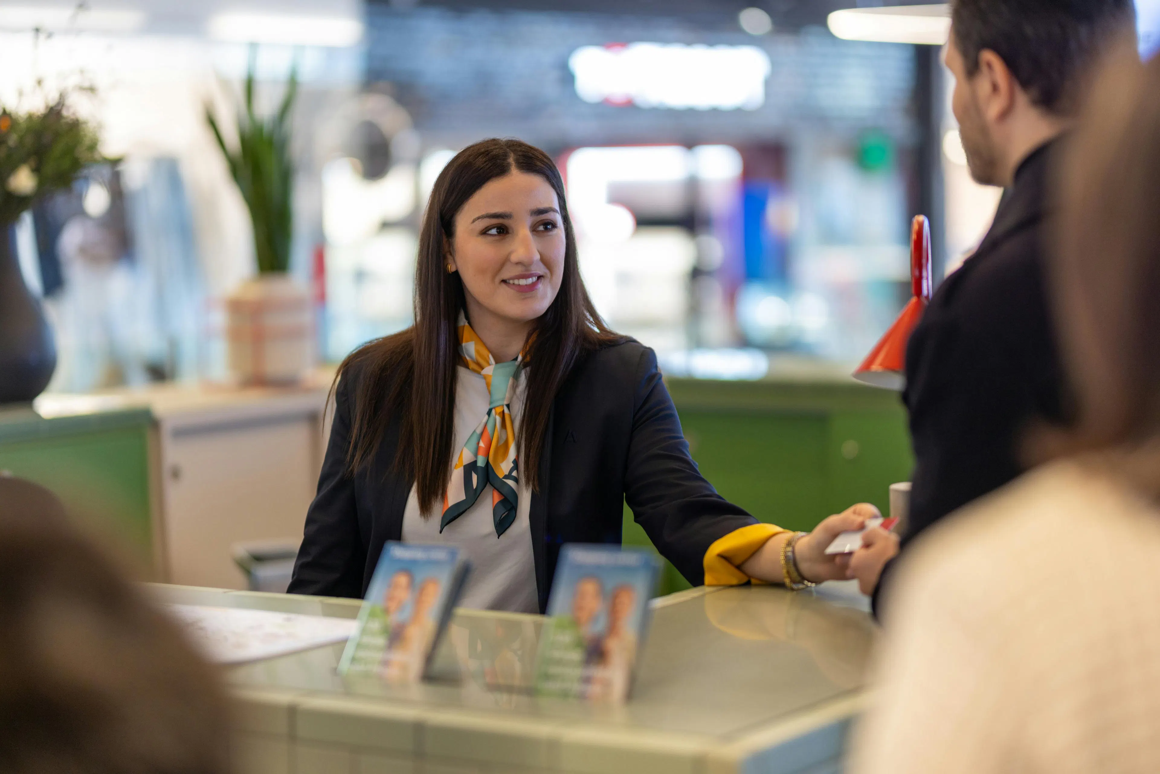 A hostess interacting with a visitor in a shopping mall