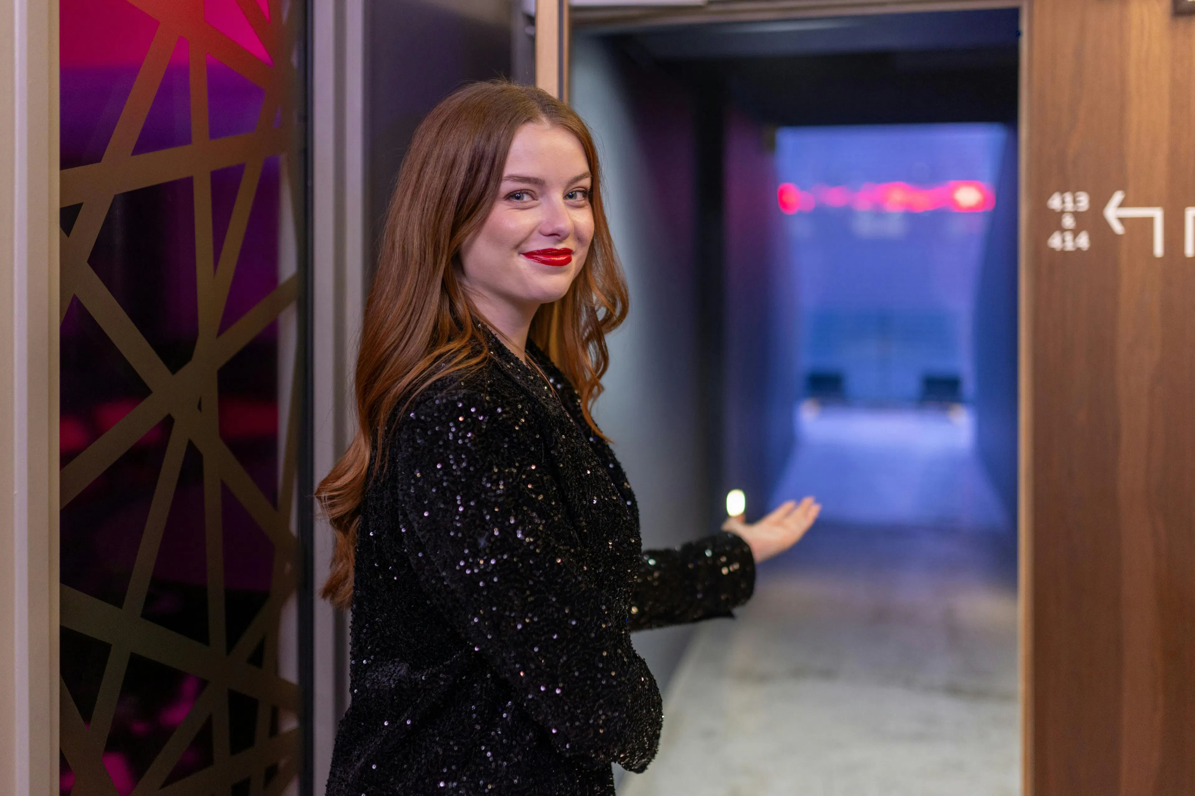 A receptionist welcoming a visitor