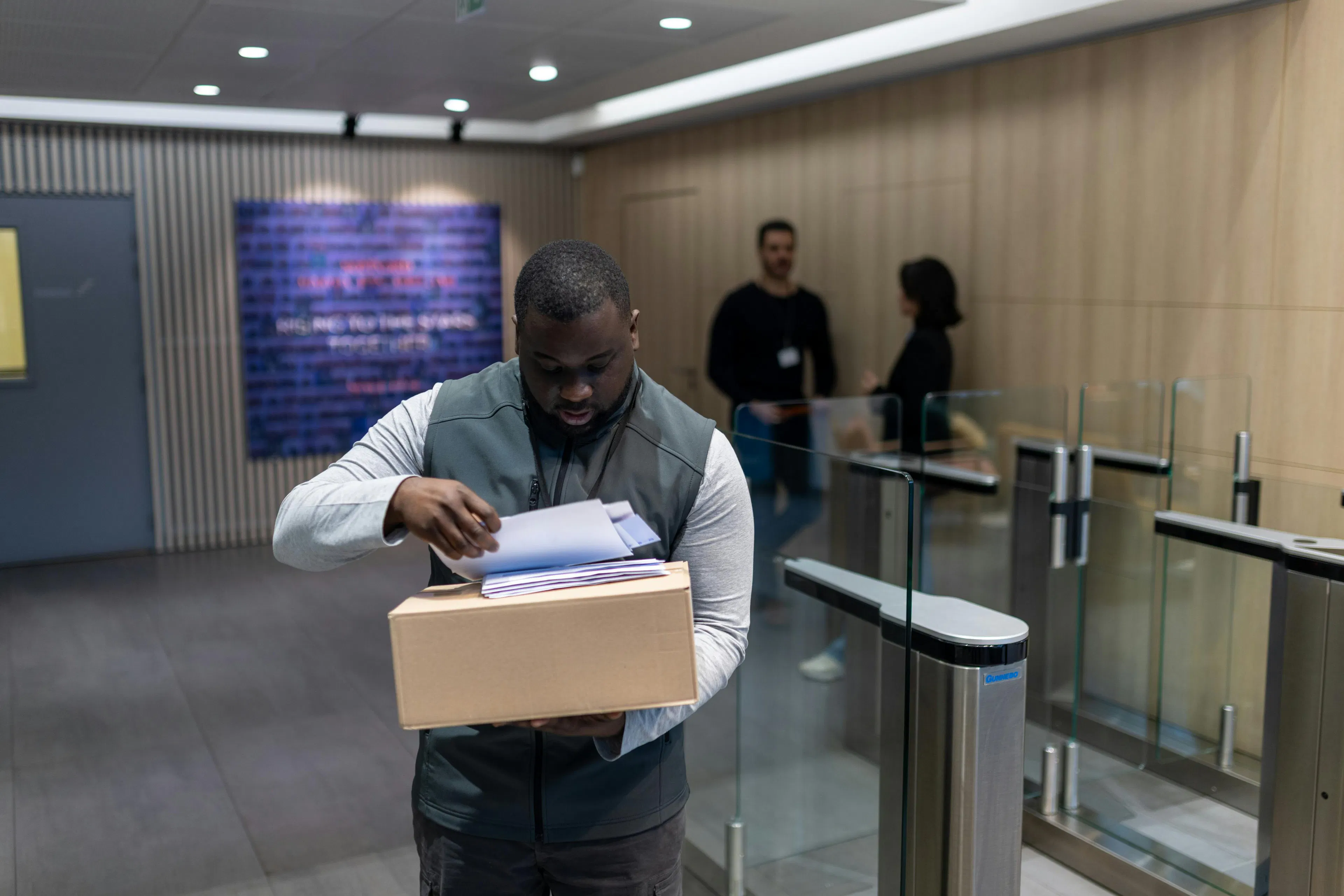 A documentation officer ready to deliver a parcel and mail to a colleague