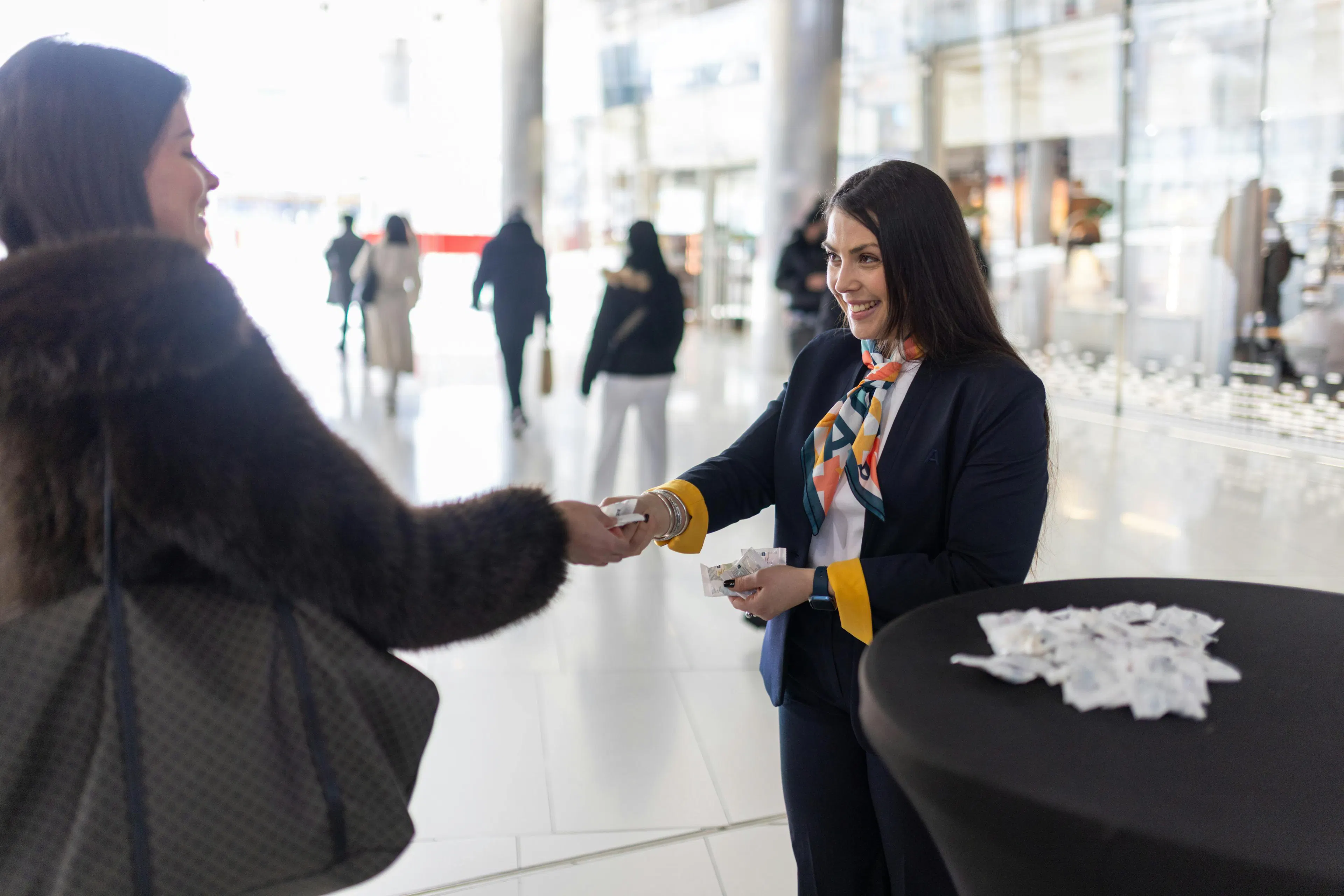 A receptionist smiling at a visitor in a shopping center