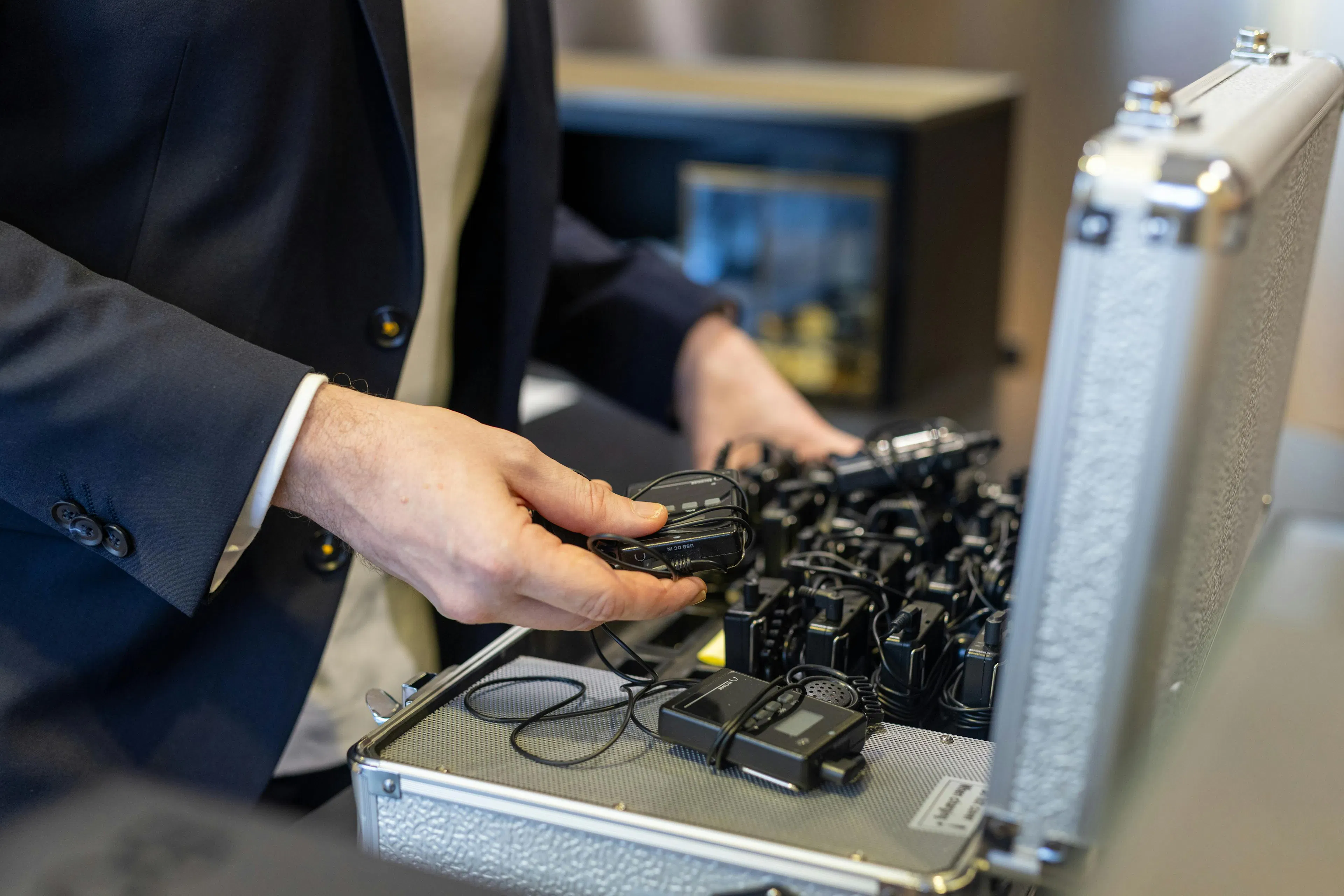 A mediator putting away audio guides in its case