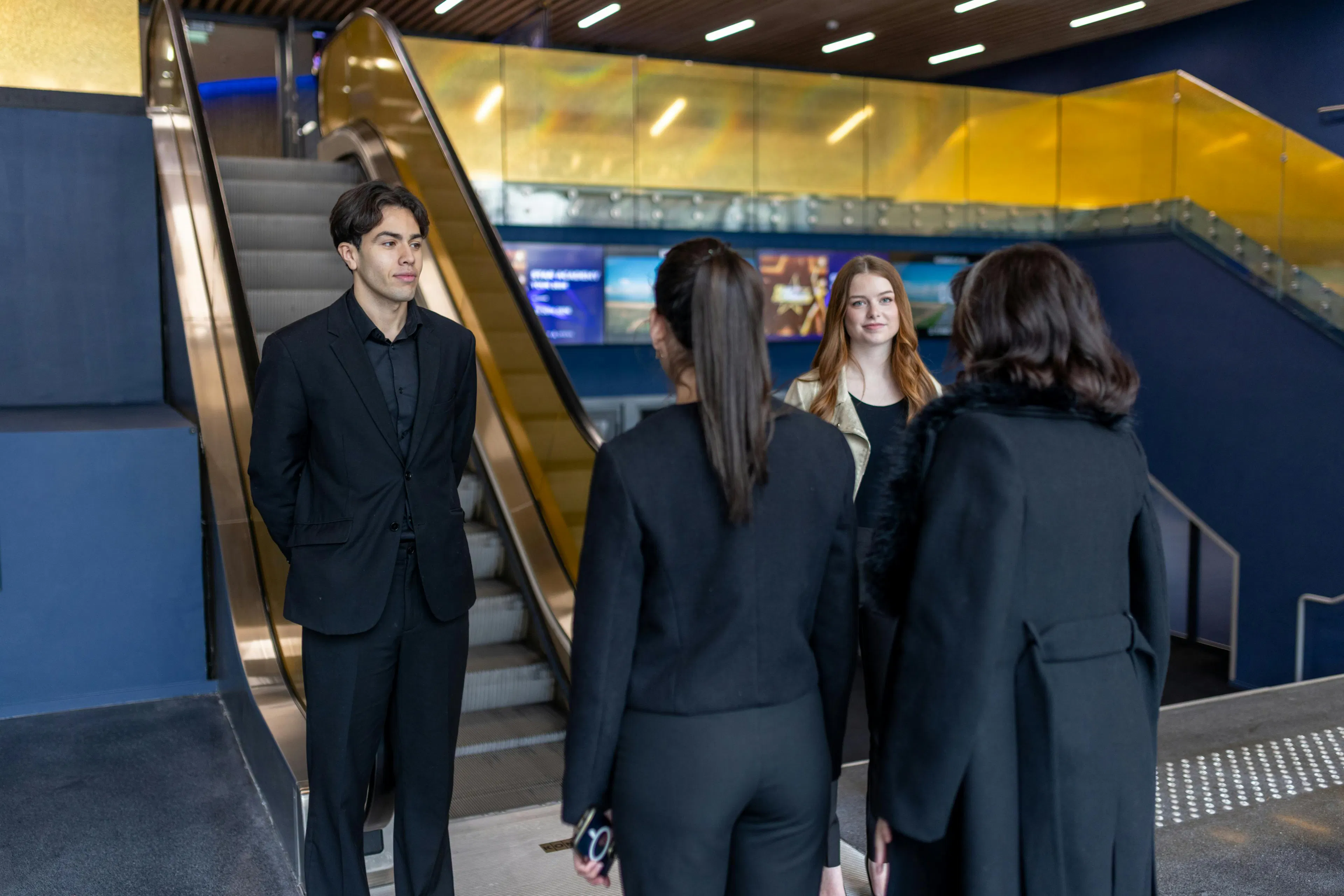 Two hosts welcoming visitors at an event venue