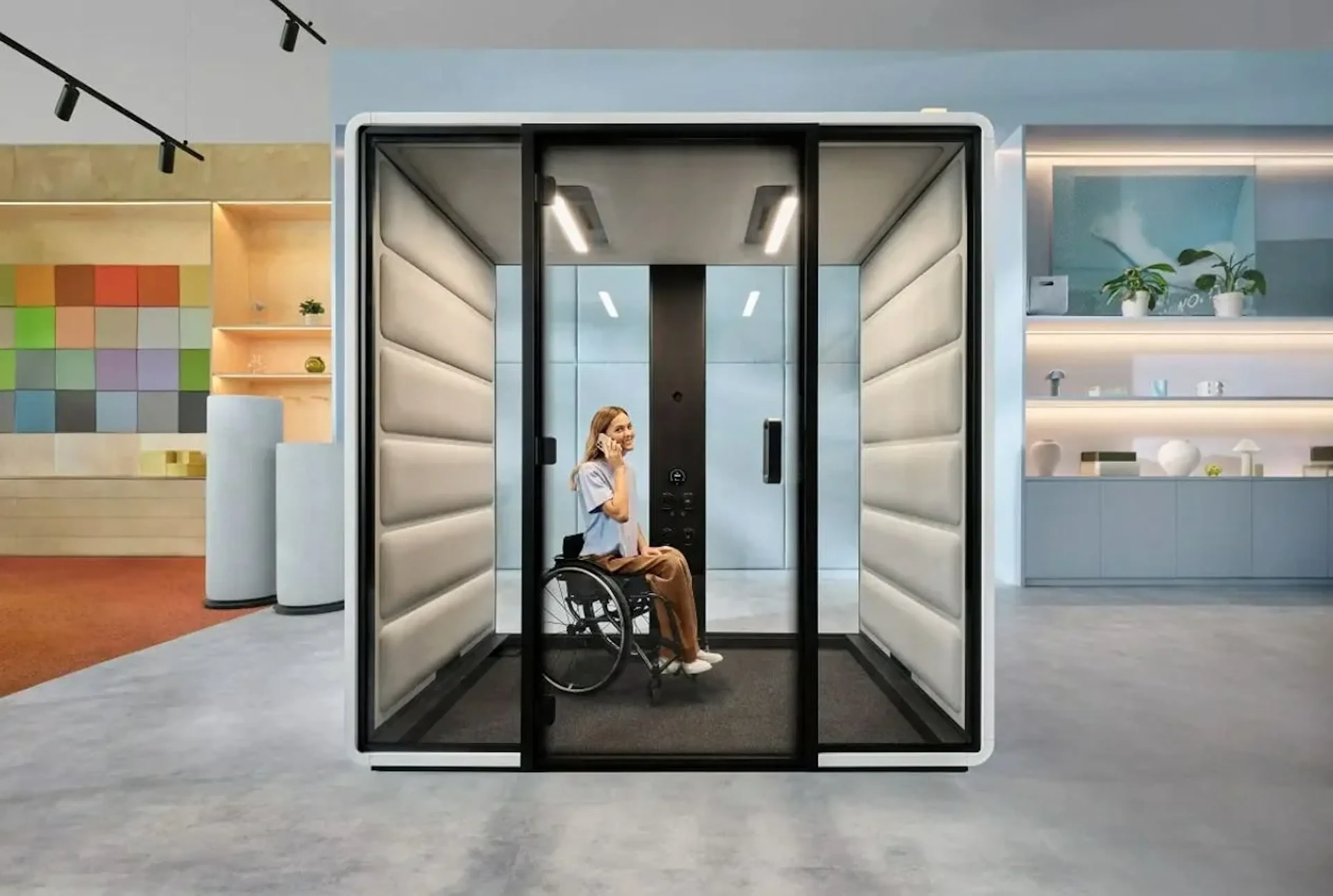 trabajador en silla de ruedas dentro de una cabina de privacidad
