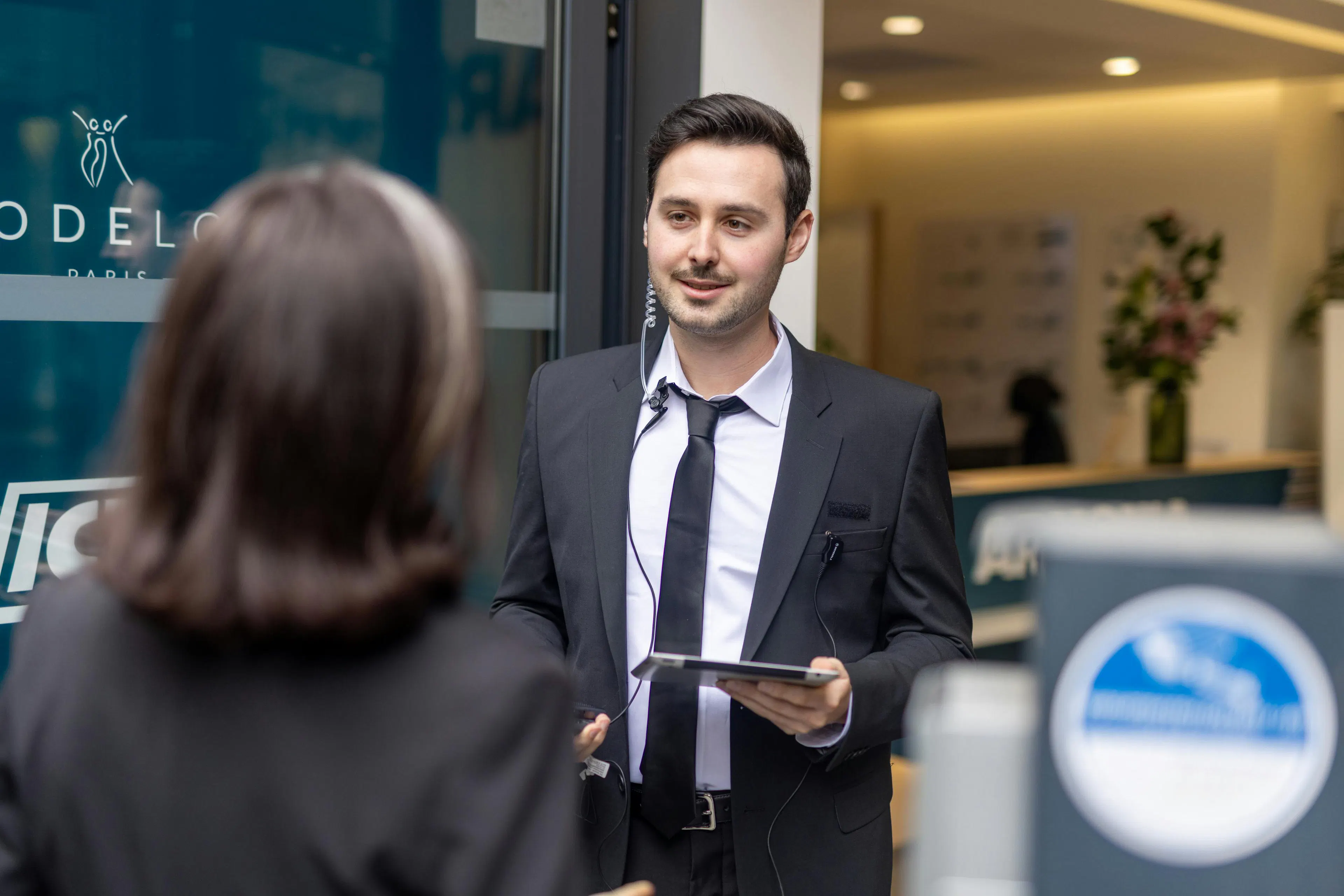 Security professional managing access at a workplace entrance