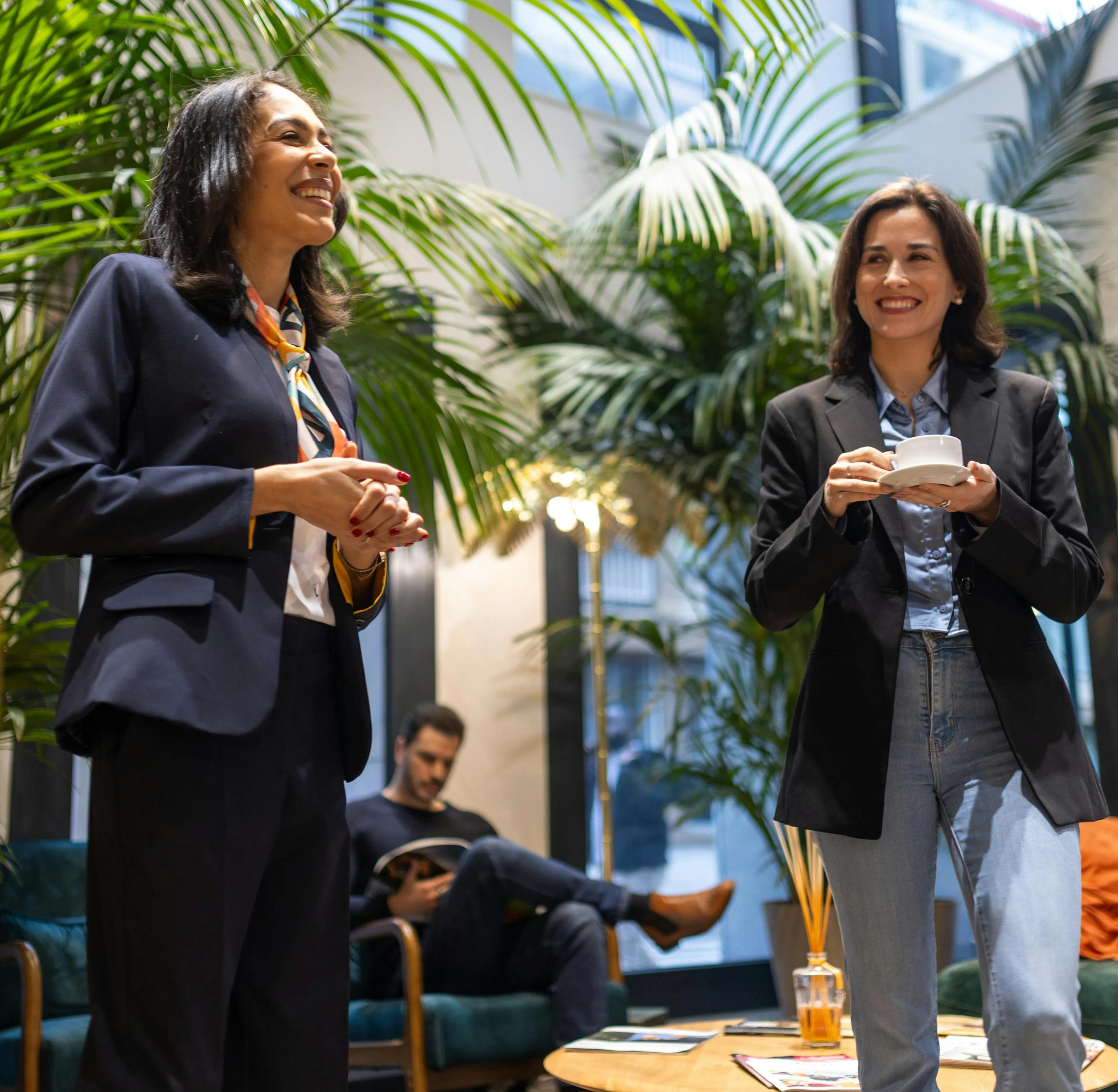A hostess welcomes a visitor in a work environment