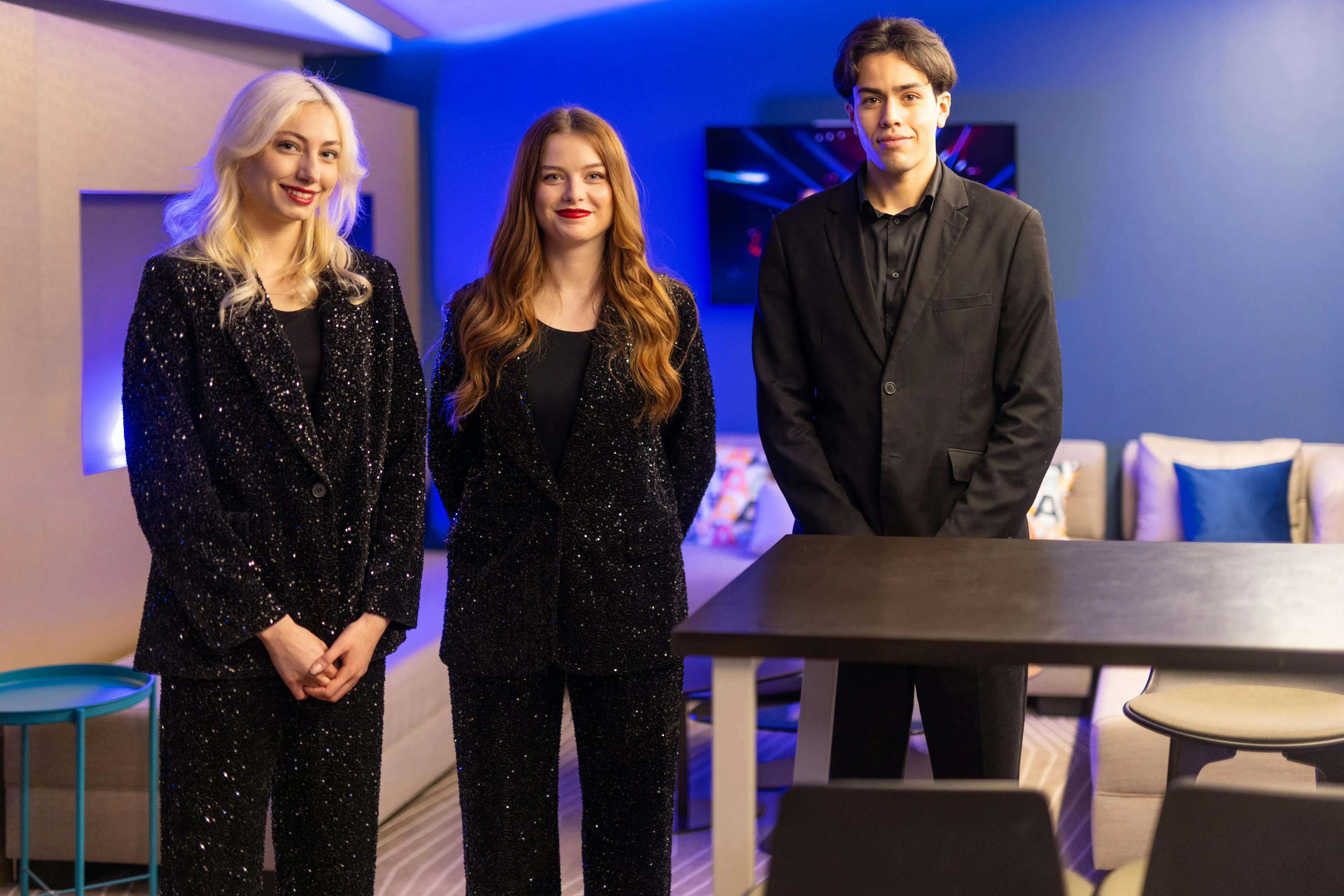 Two hostesses and one host at an event venue