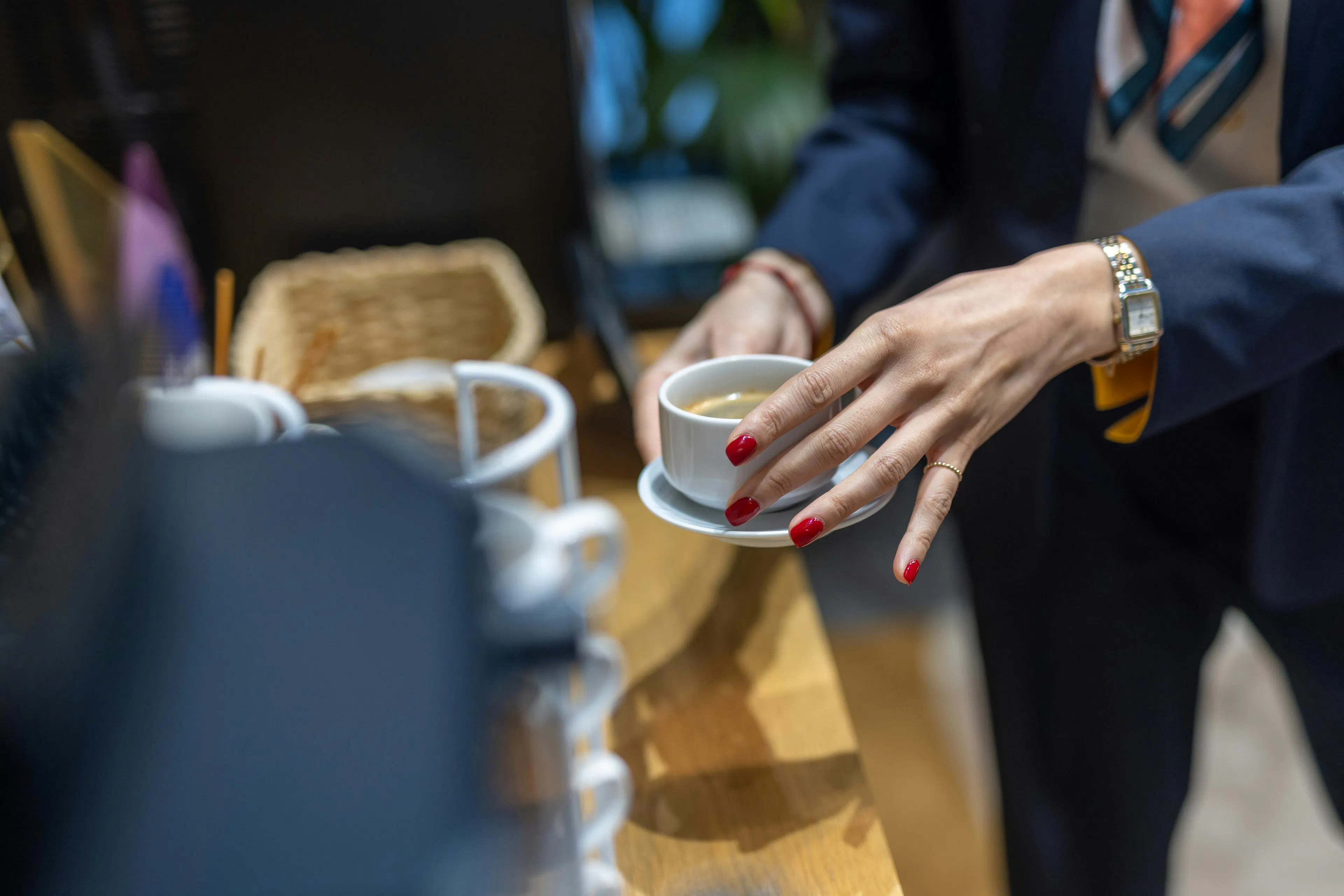 A receptionist preparing a coffee for a visitor