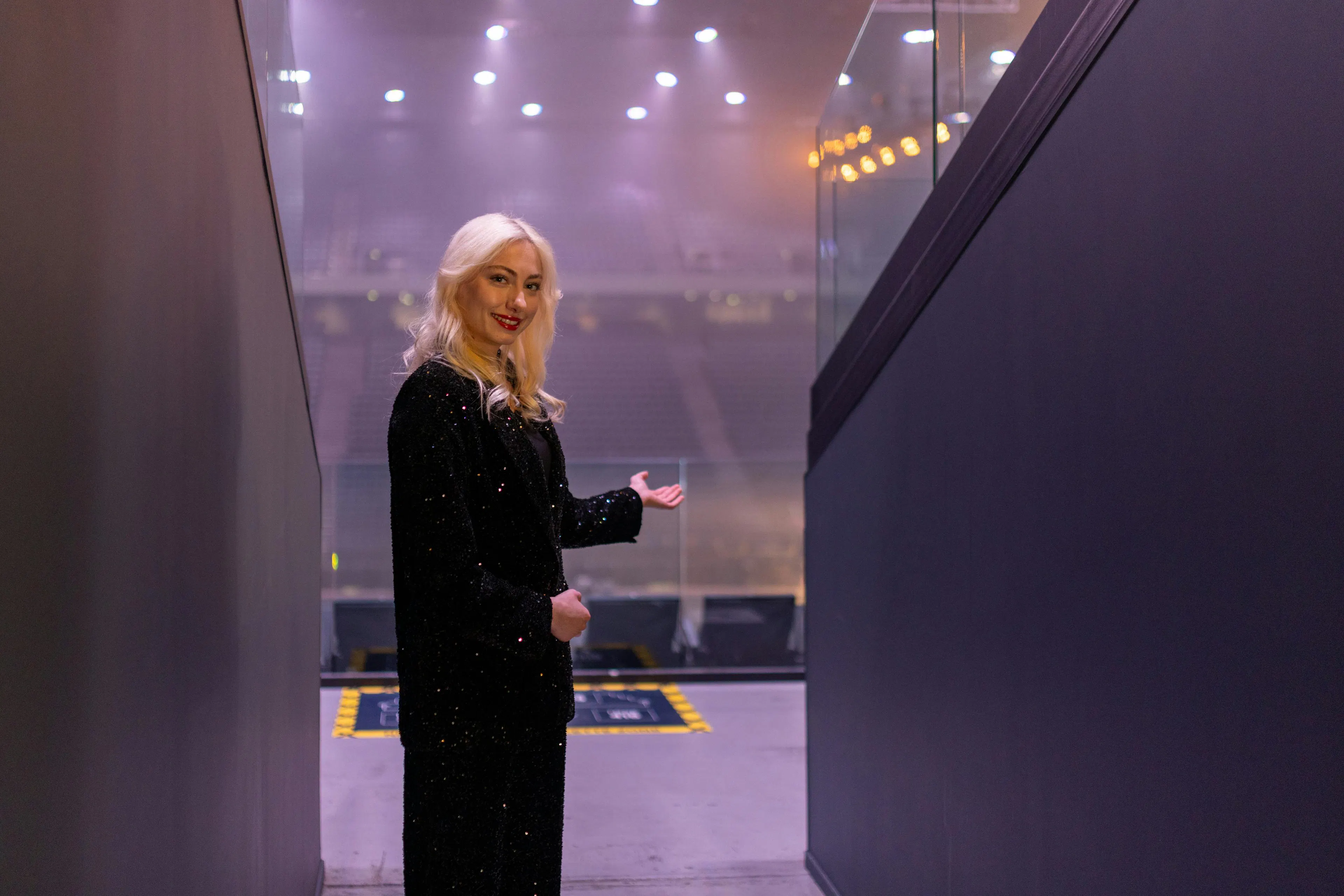 A hostess welcoming visitors inside an event site