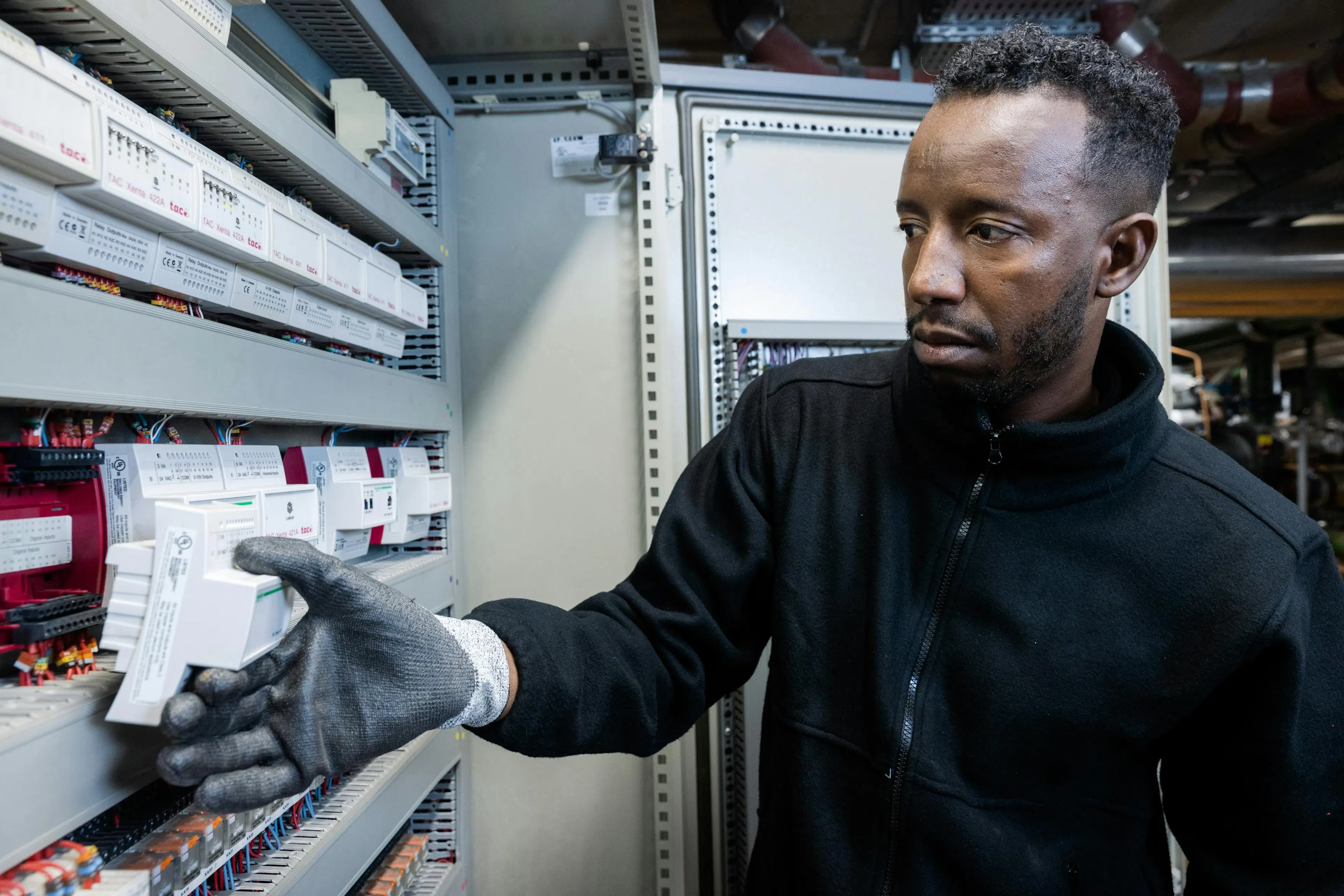 Technician inspecting technical equipment in a building