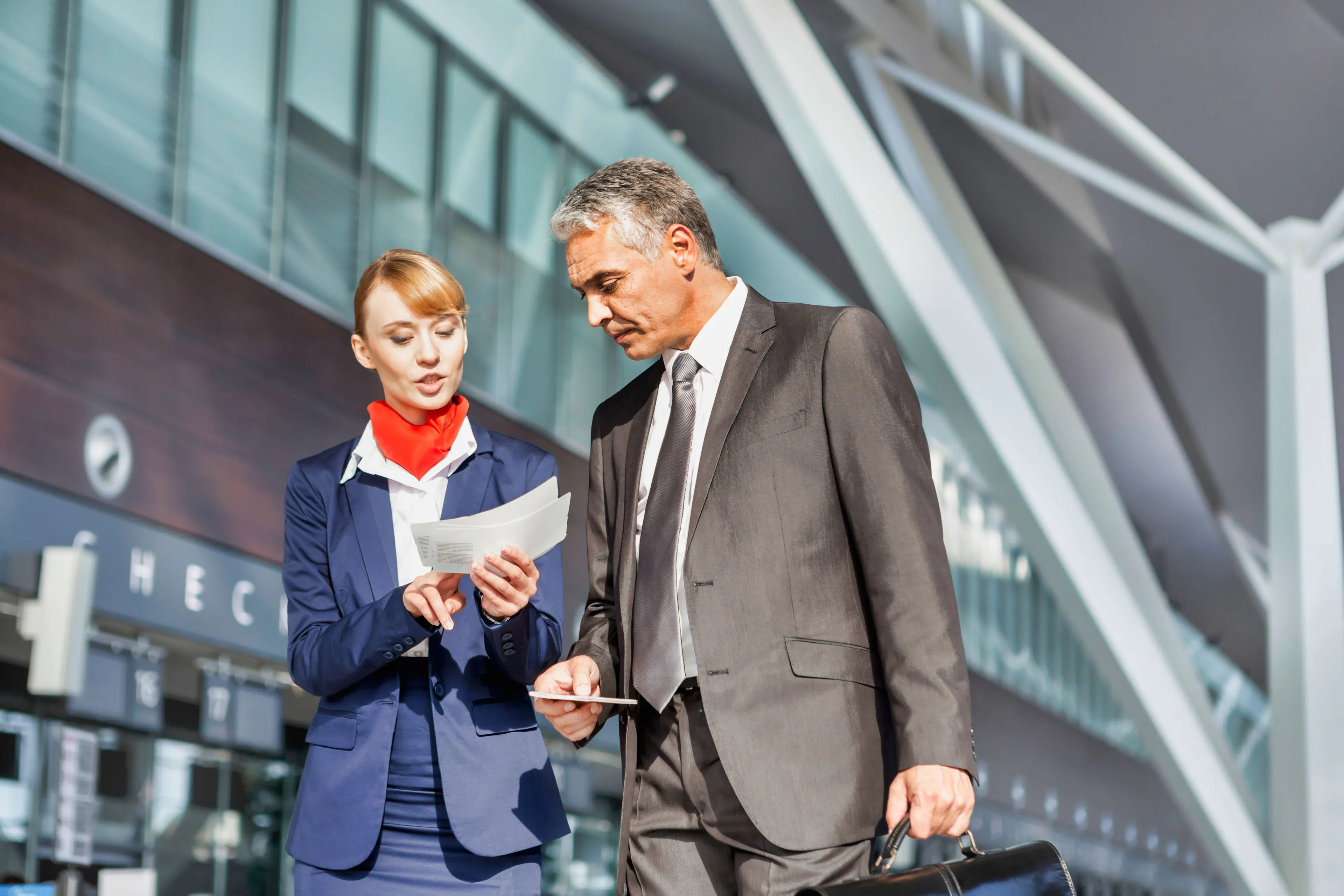 An airport agent assisting a passenger