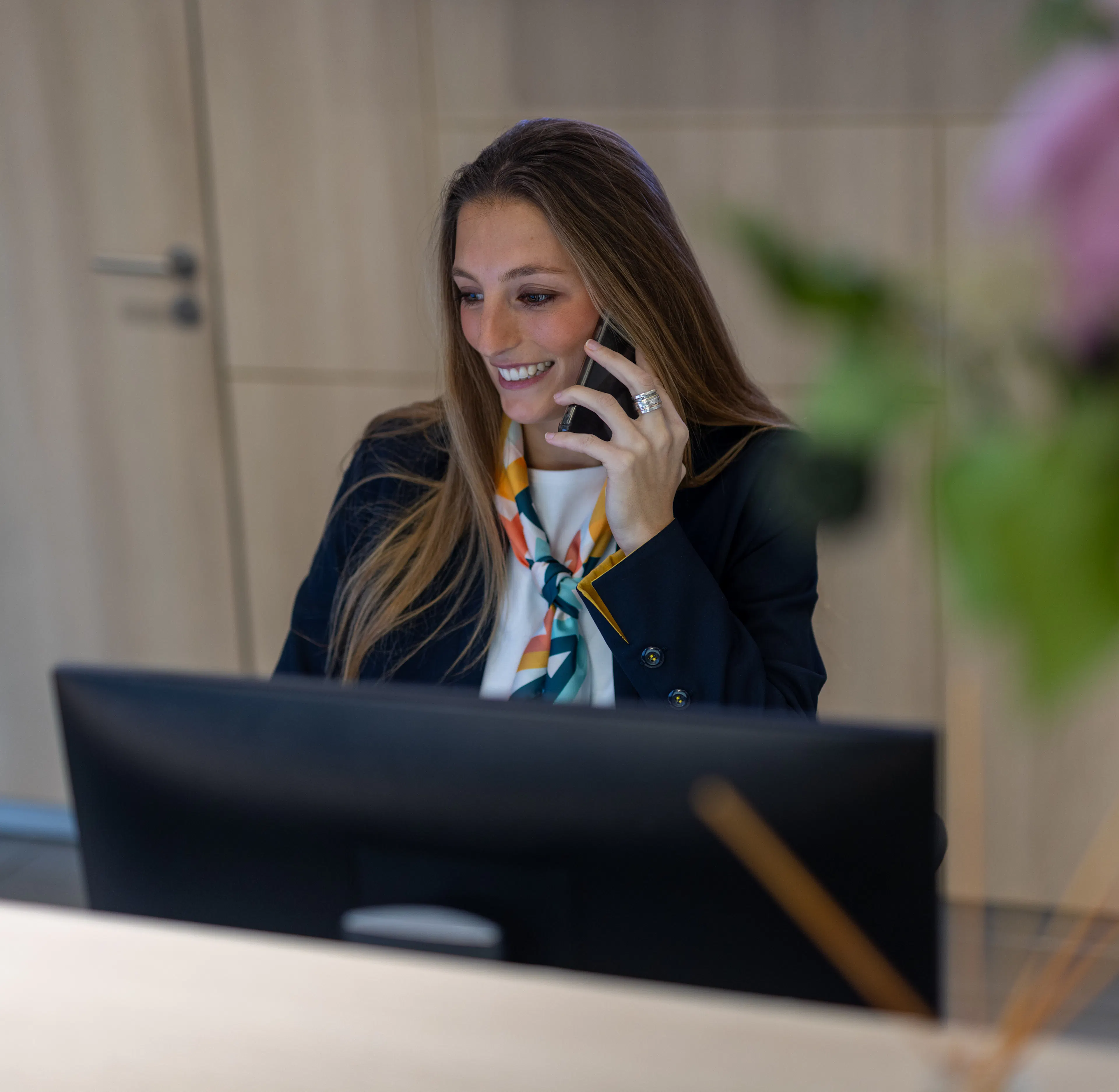 Une hôtesse d'accueil souriante au téléphone