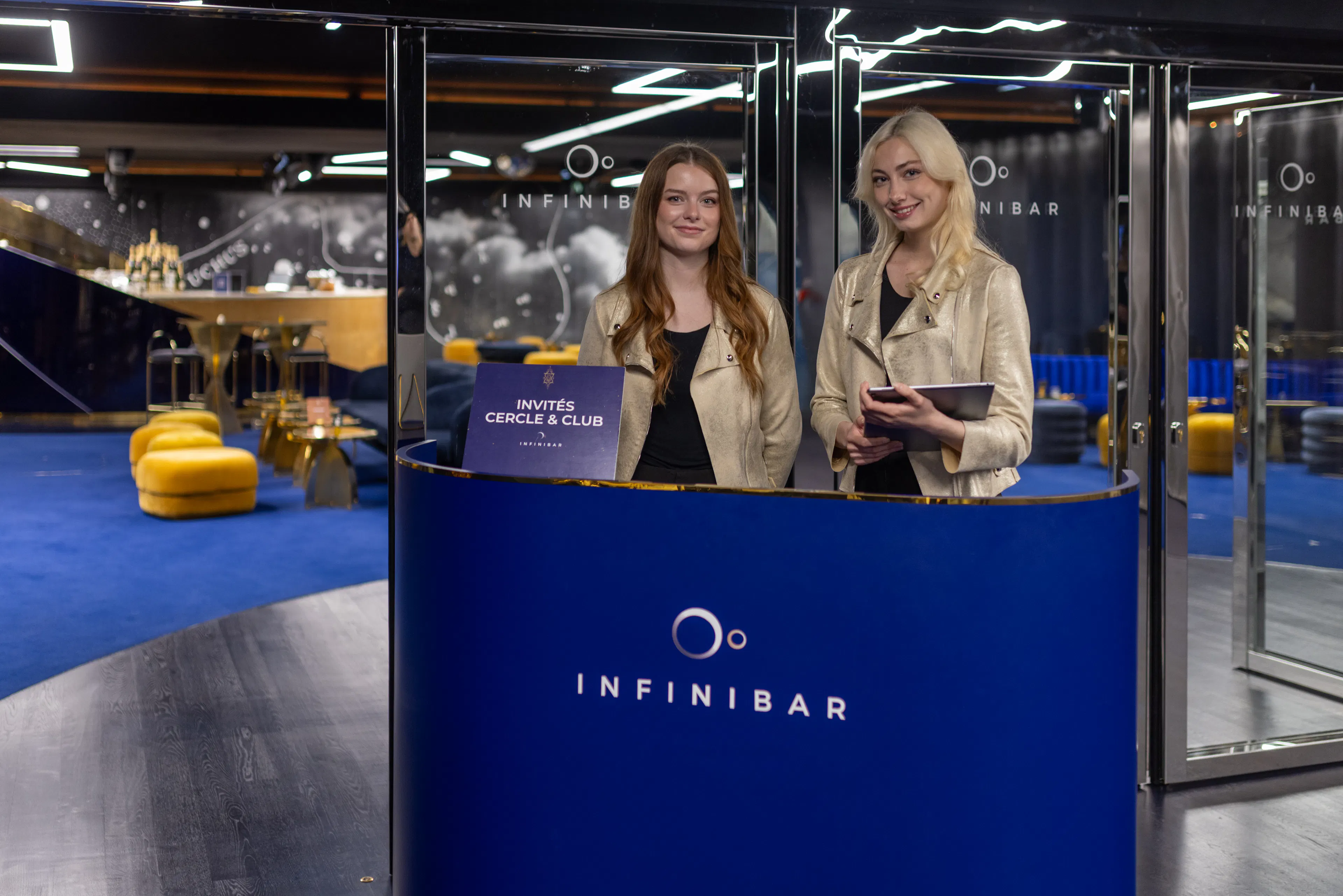 Two reception hostesses smiling at an event site