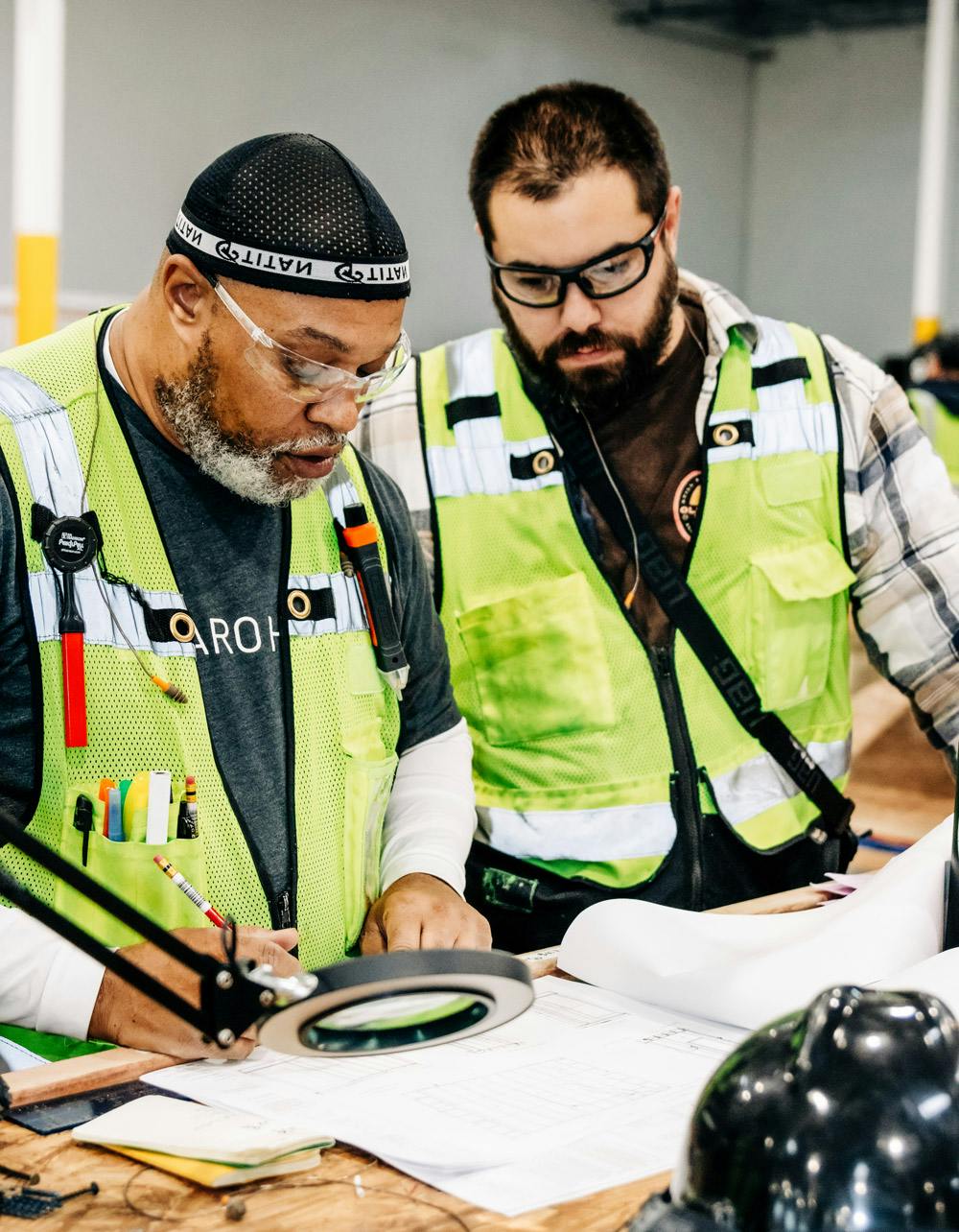 2 workers looking over architectural plans