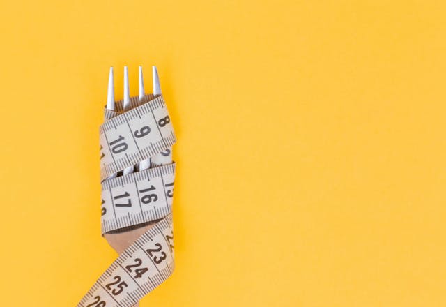 benefits of eating lean fish like tilapia, illustration of a fork wrapped by tape measure indicating weight loss