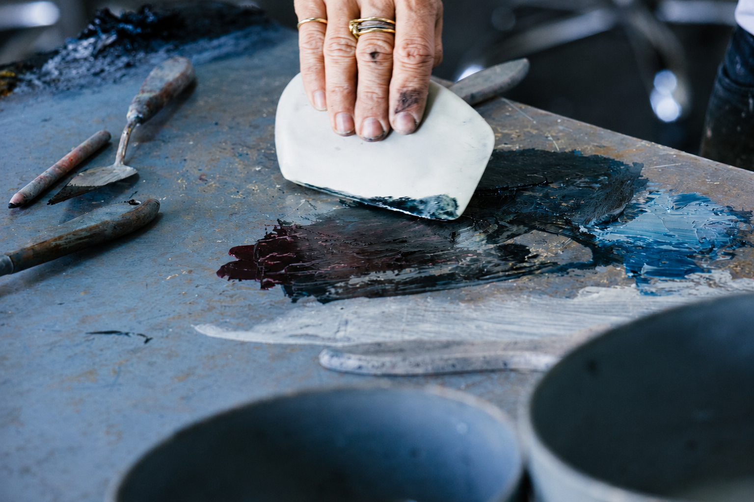 person applying cold wax onto canvas