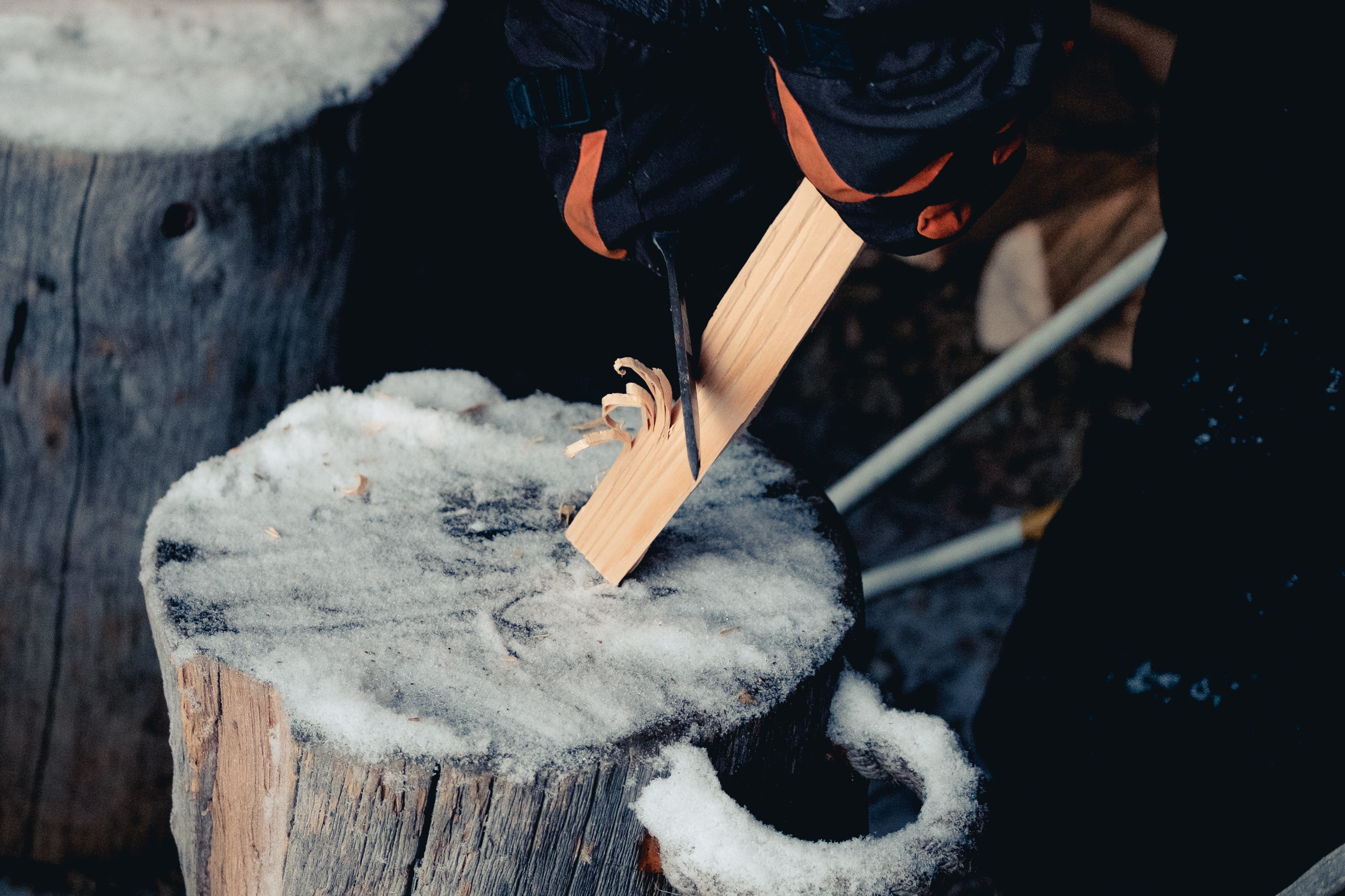 someone carving a stick with a knife