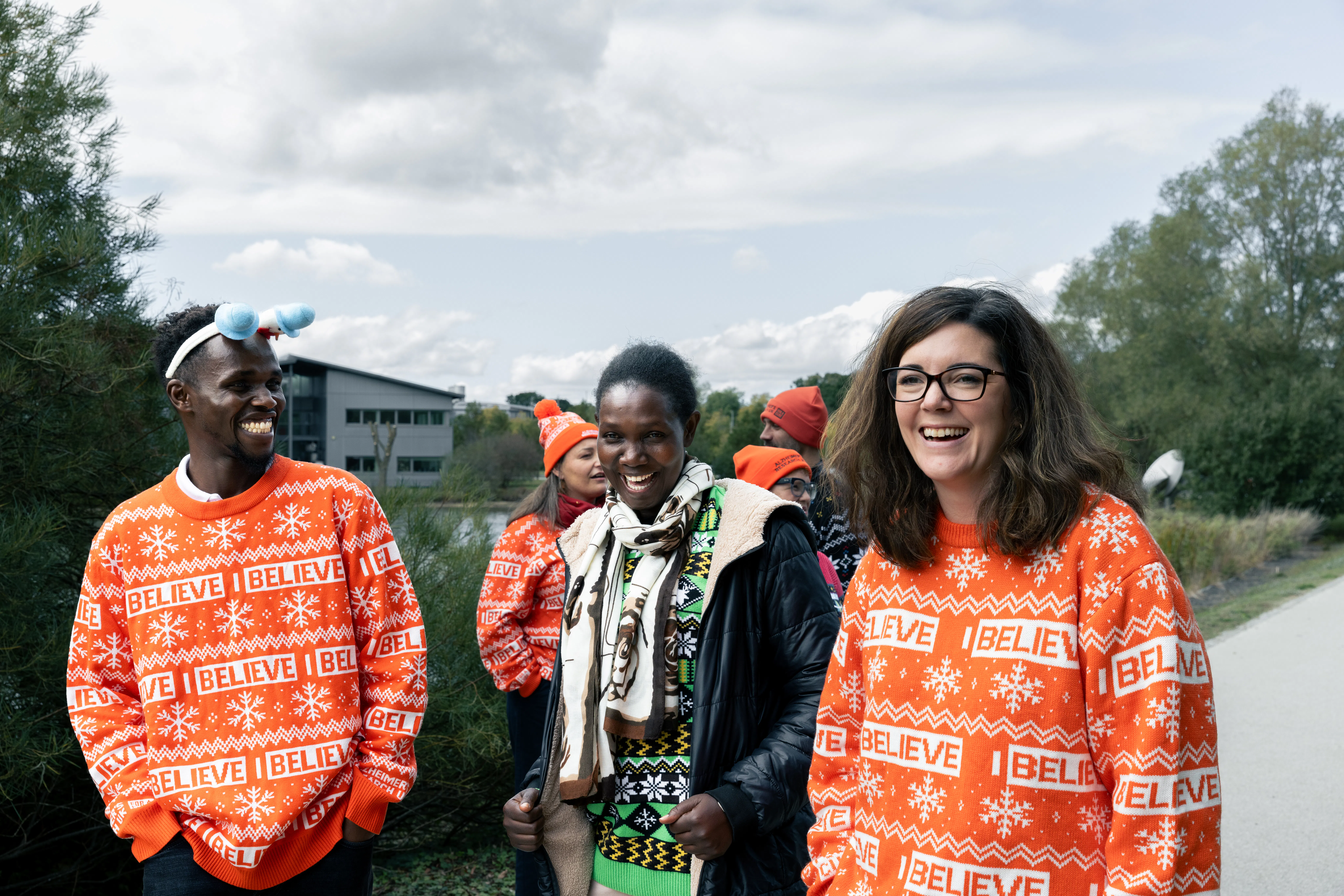 Alzheimer's Research UK supporters on a walk in festive orange jumpers.