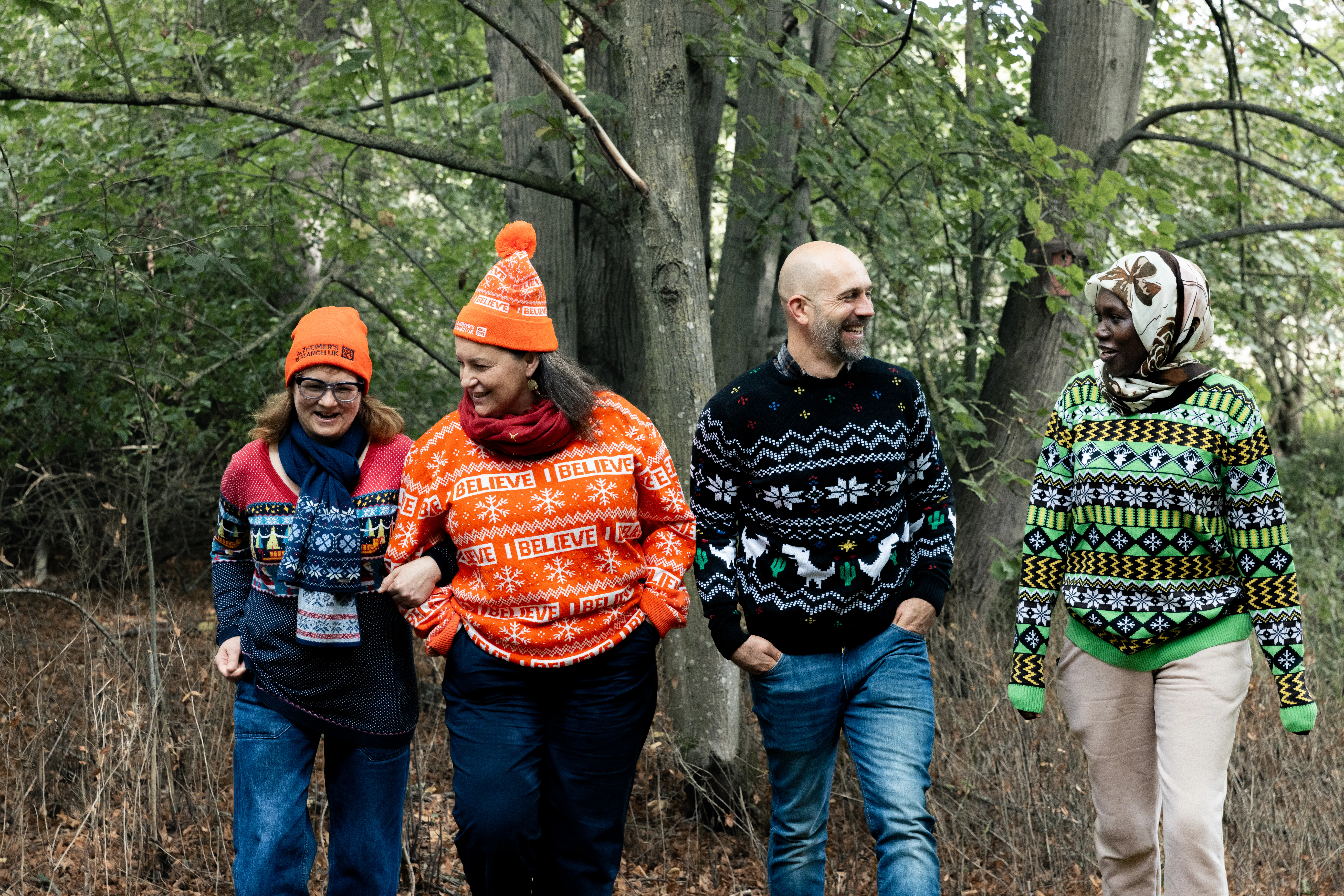 Family walking together in festive Alzheimer's Research UK jumpers.