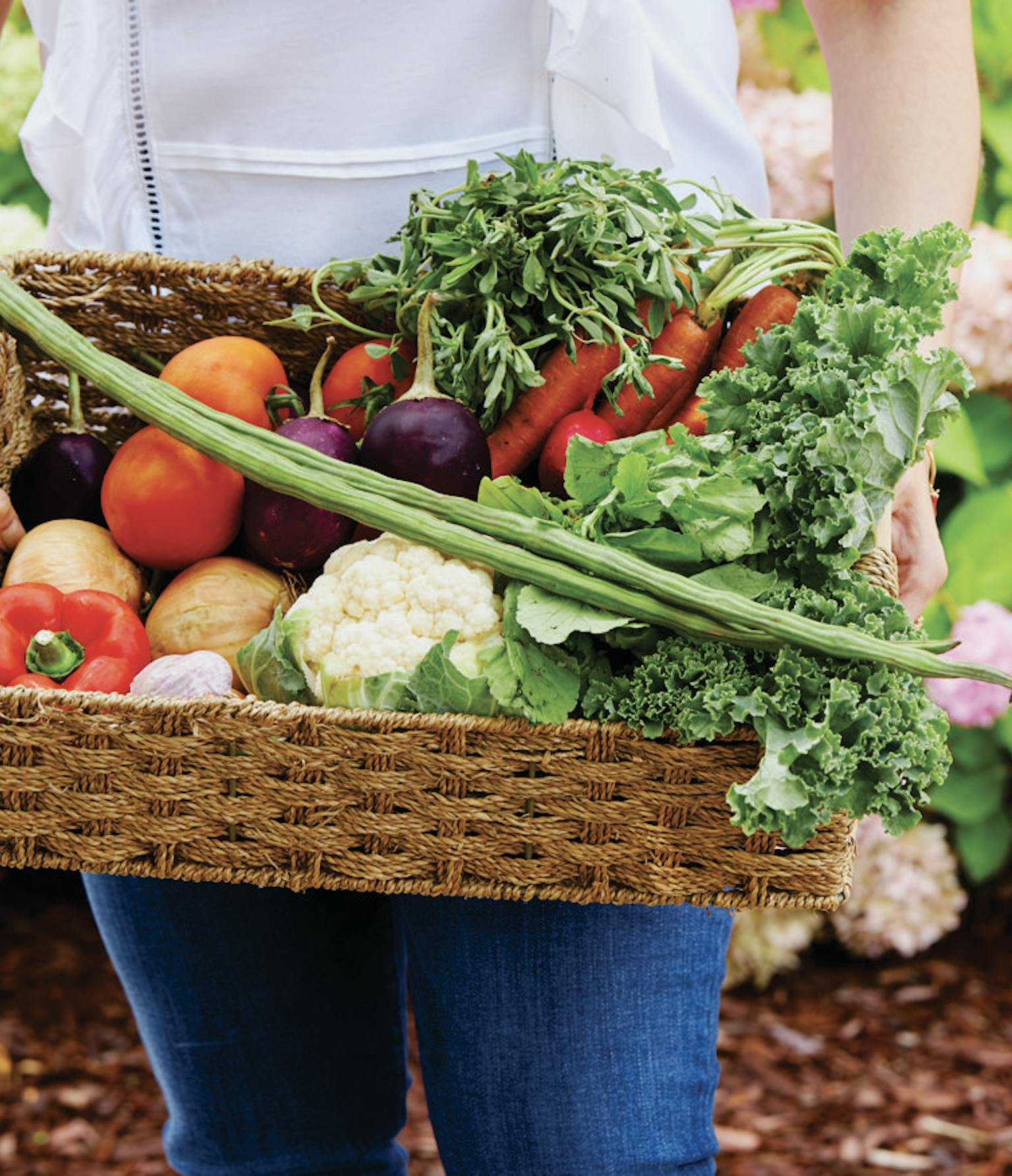 Preena holding a basket of fresh produce