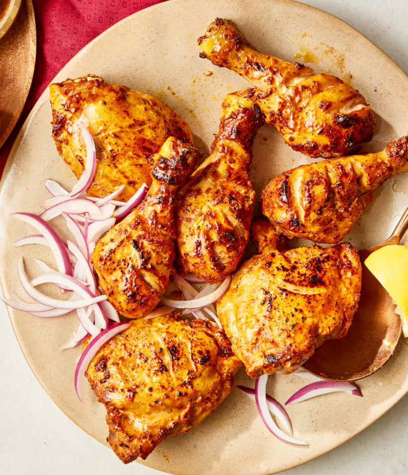 Tandoori chicken platter with lemons and chutneys