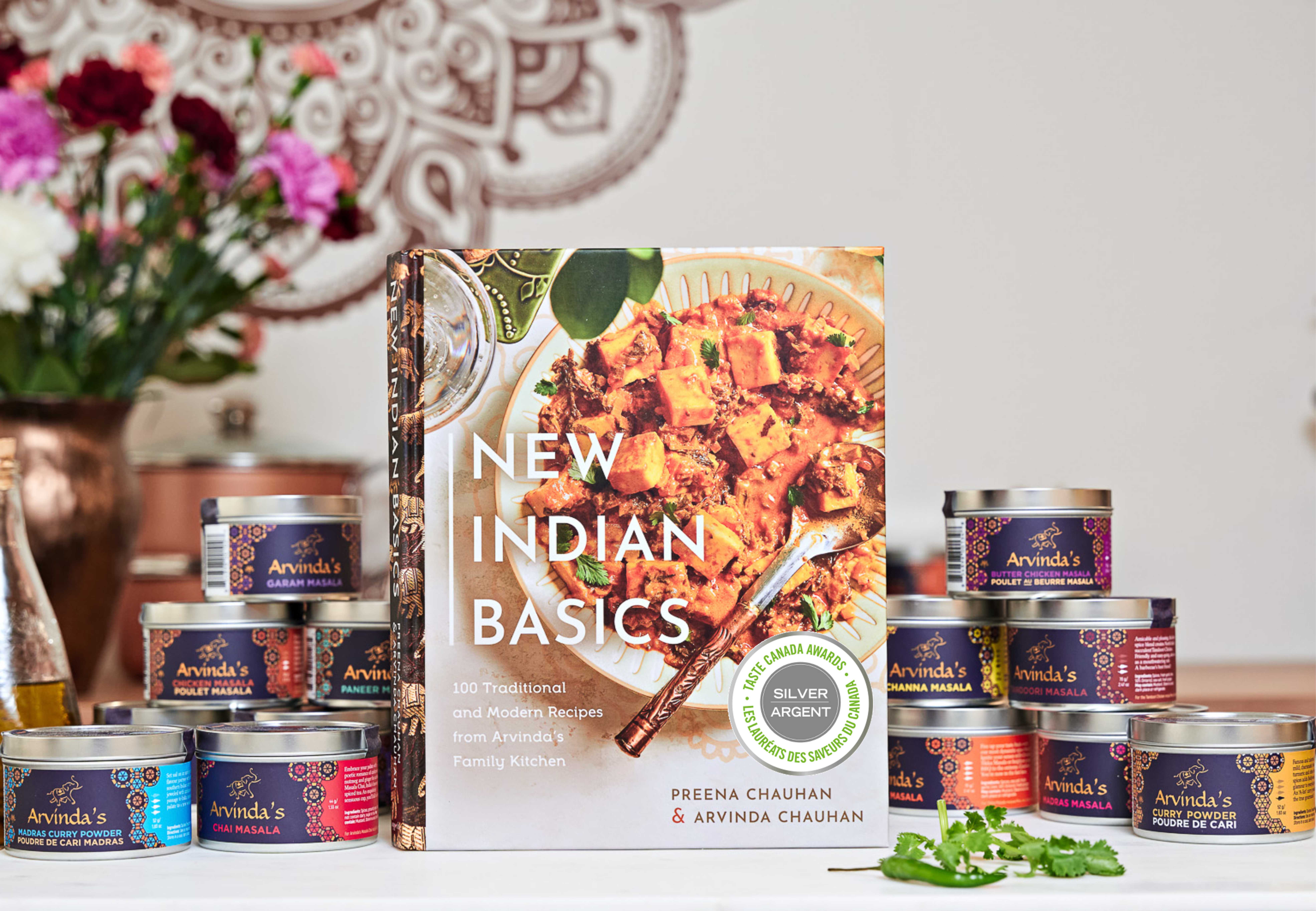 New Indian Basics with Arvinda's masala spice tins on a kitchen counter